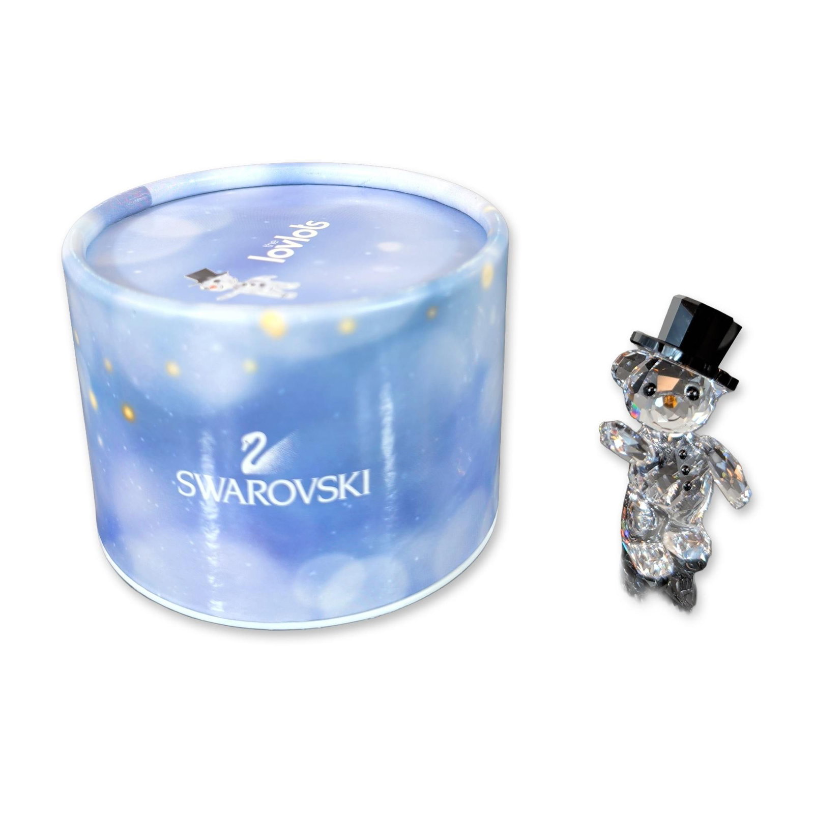 Swarovski The Lovlots Crystal Kris Bear Christmas Figurine: Swarovski figurine from the Lovlots collection depicting Kris Bear Christmas in faceted clear crystal. The bear wears a black crystal top hat, black crystal eyes and buttons, and a pointed orange crys