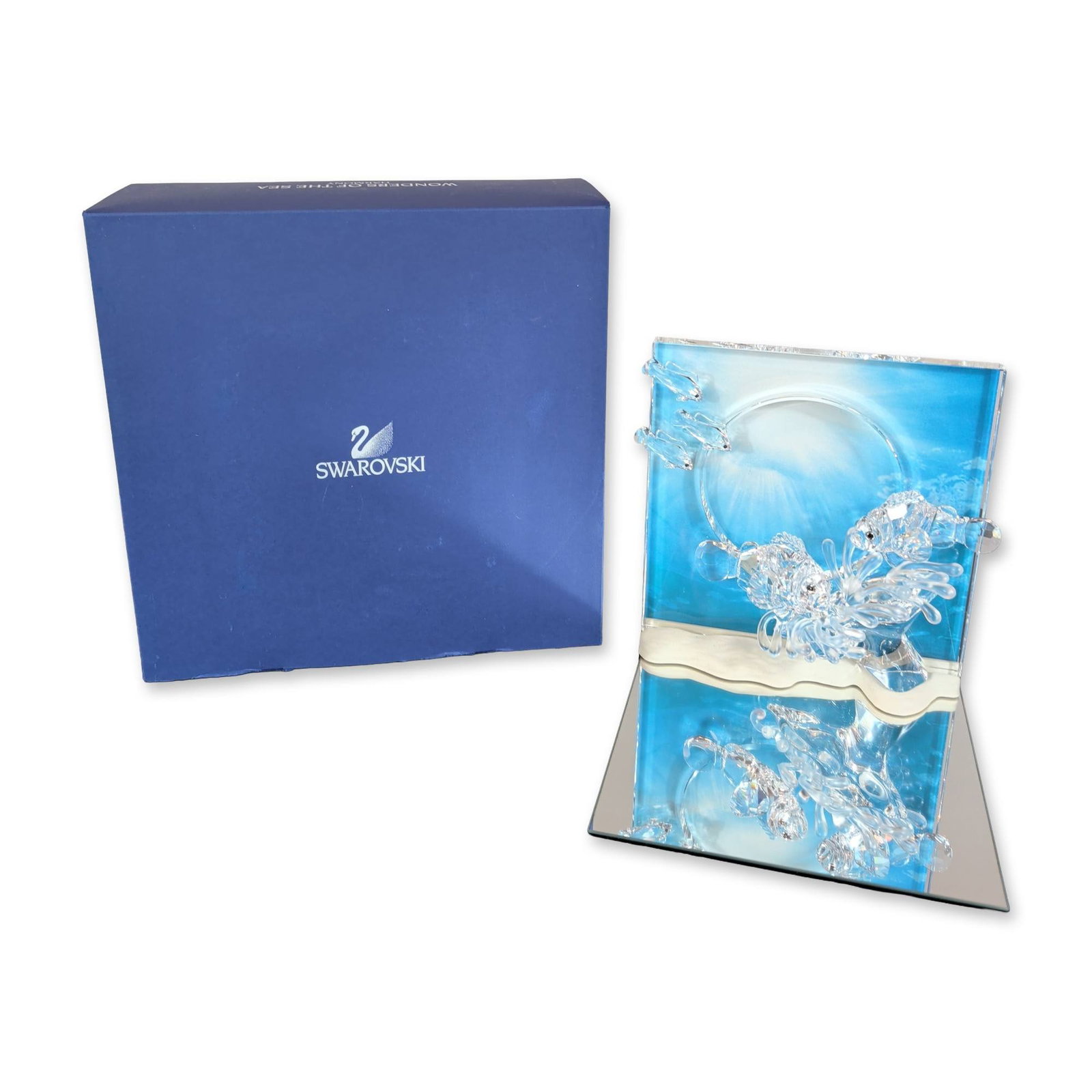 Swarovski Wonders of the Sea Harmony Crystal Figurine: Crystal sculpture from the Wonders of the Sea series, titled Harmony. The piece is constructed of facet-cut clear and frosted crystal, depicting fishes swimming through coral-like forms. The crystal e