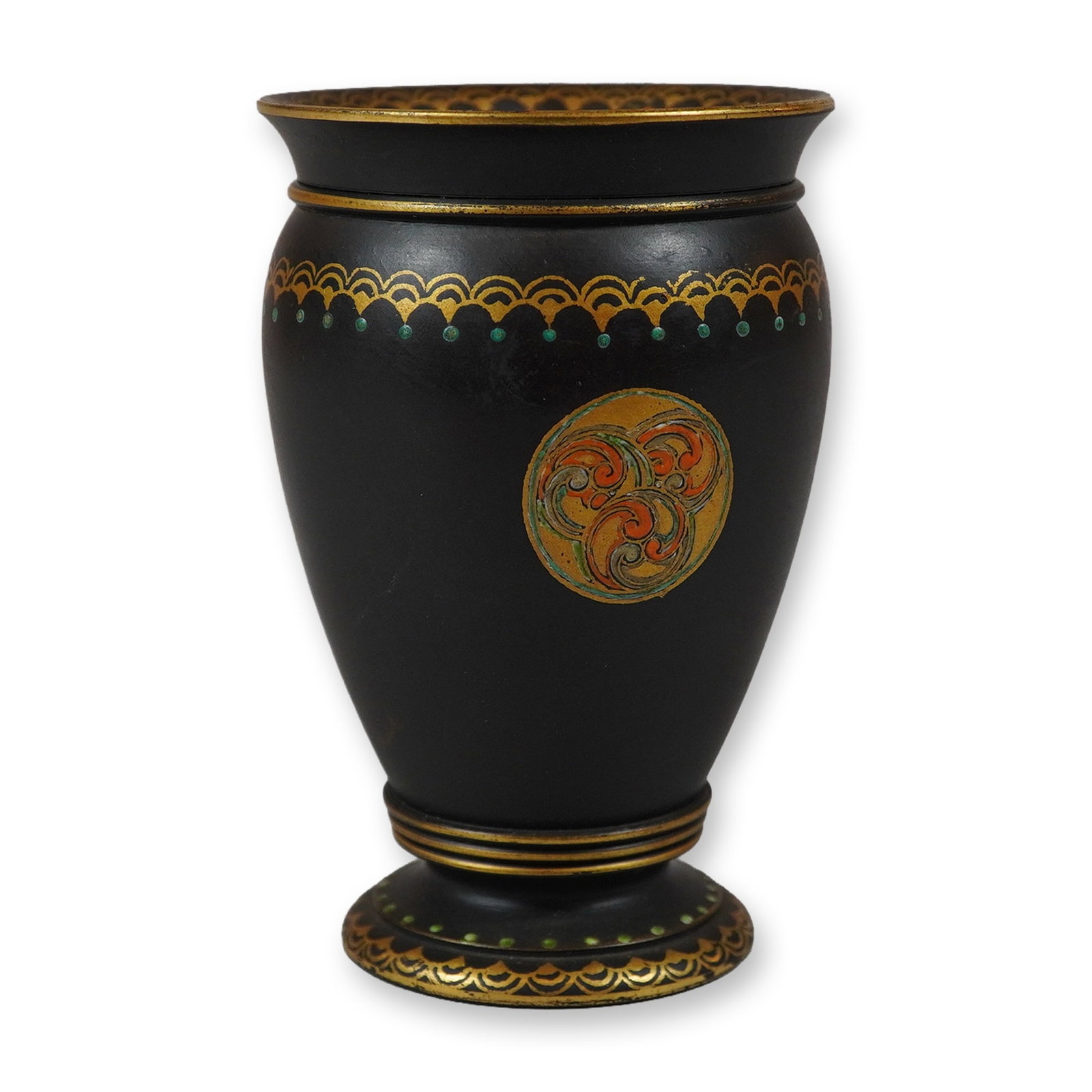 Wedgwood Black Stoneware Enameled and Gilded Bud Vase, c. 1900: The vessel is designed with a flared rim, a bulbous body, and a pedestal foot. The body is ornamented with two circular medallions on opposing sides. One medallion contains a triple-spiral triskele mo