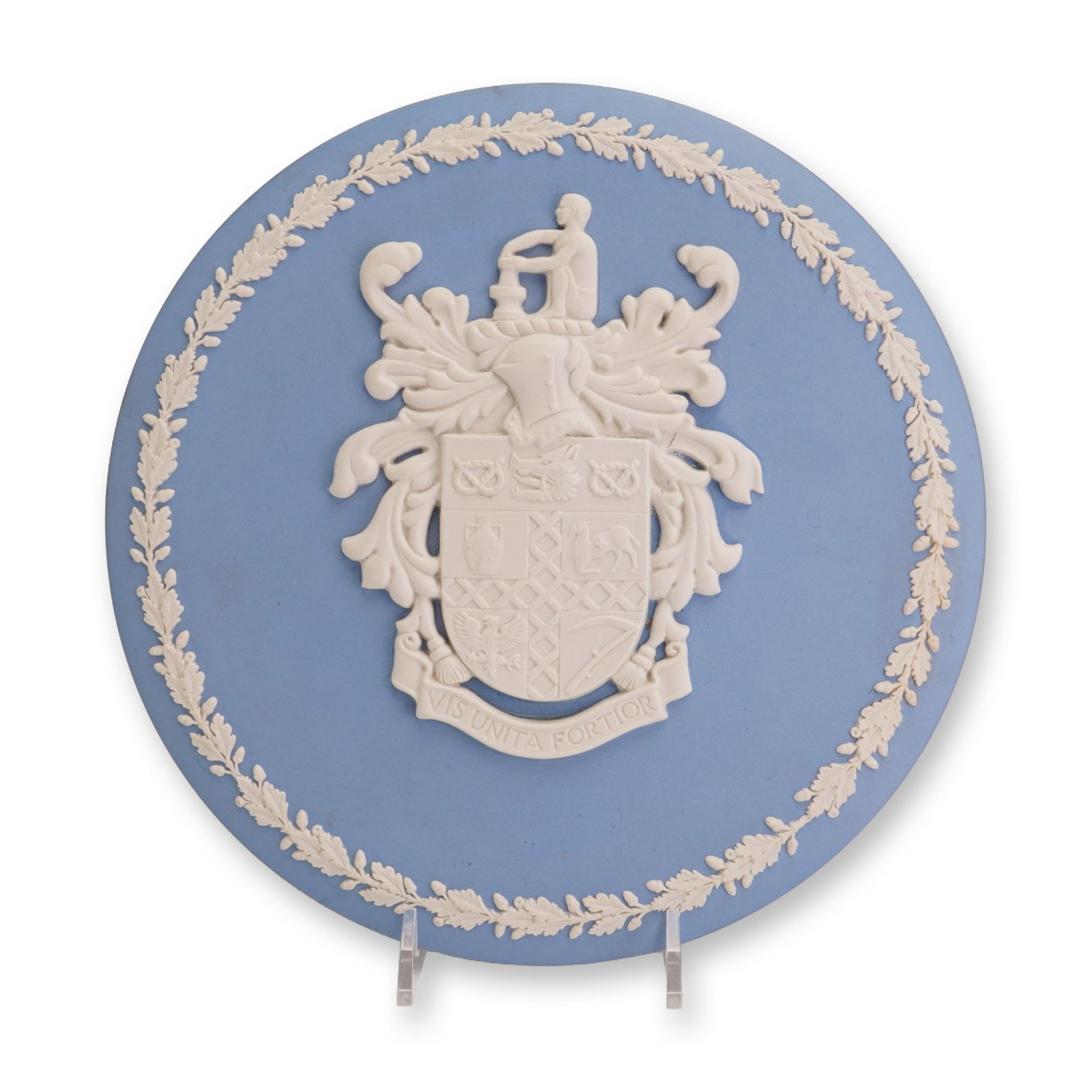 Wedgwood Blue Jasperware Circular Plaque Featuring the Stoke-on-Trent Coat of Arms: This circular plaque is crafted from Wedgwood jasperware, a distinctive matte stoneware. The piece features a light blue ground decorated with sprigged bas-relief in white clay. The central design dep