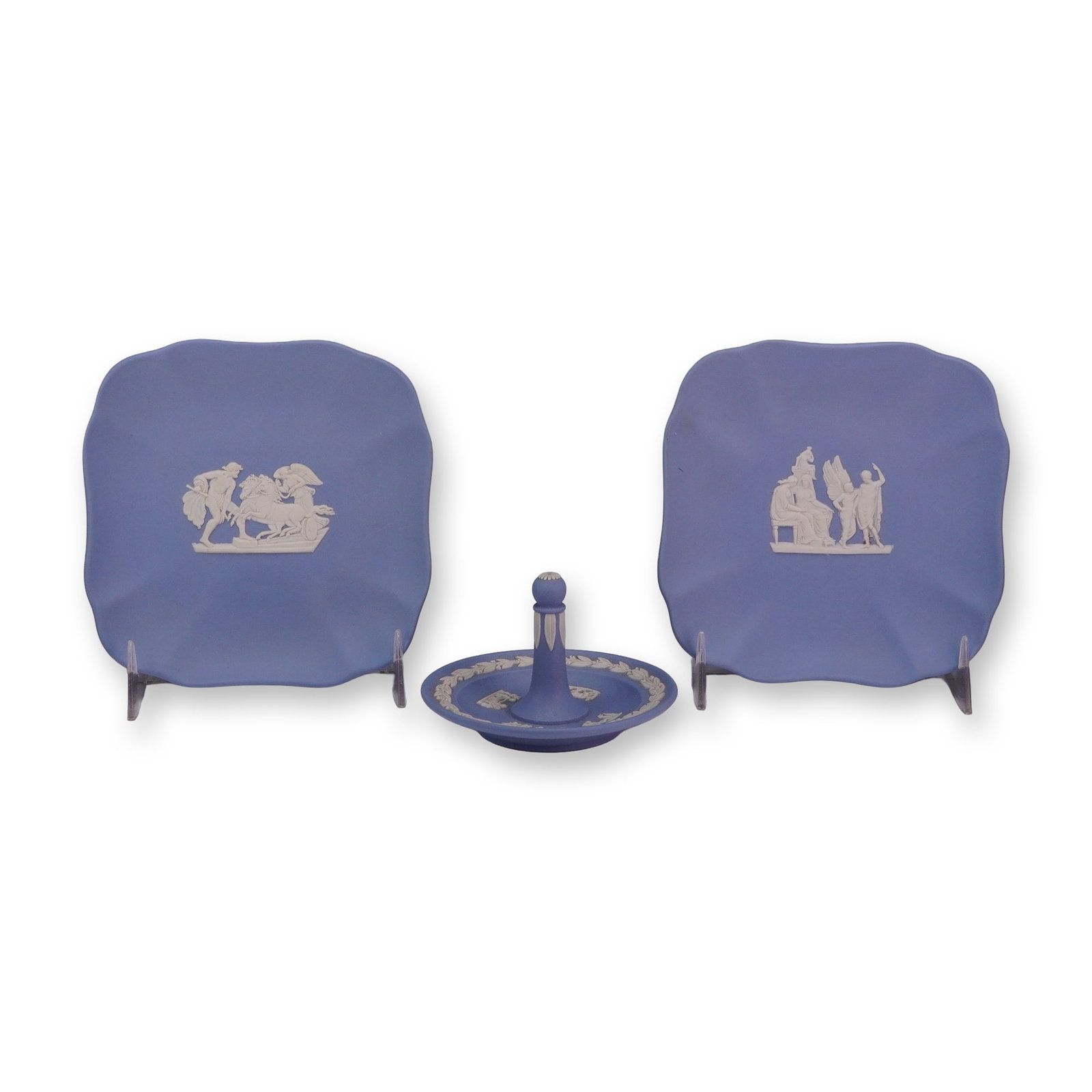 3pc Wedgwood Pale Blue Jasperware Trinket Dishes and Ring Holder: This grouping of Wedgwood jasperware includes three pale blue pieces with white bas-relief decoration in the neoclassical style. The set consists of two square pin trays with scalloped edges and mytho