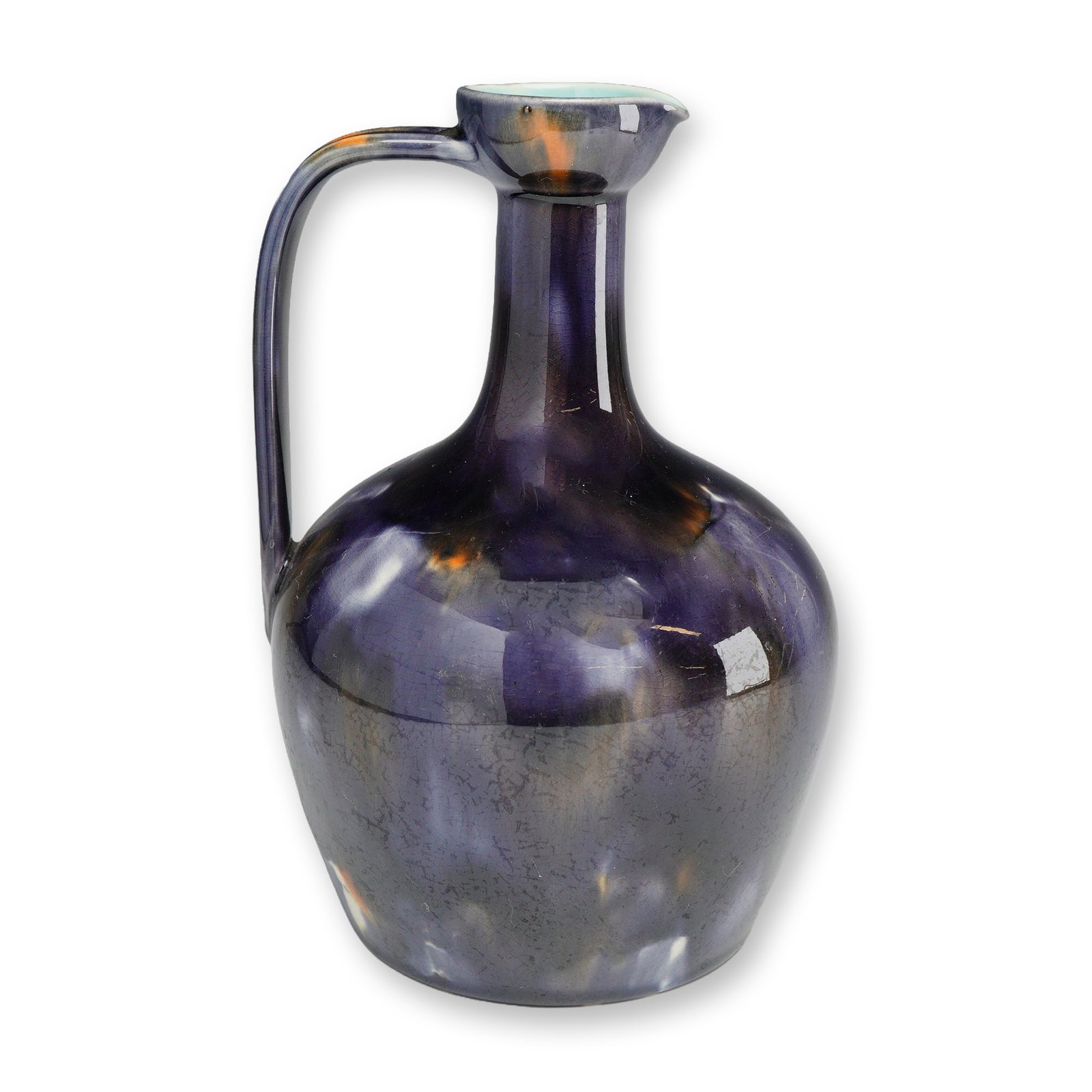 Wedgwood Mottled Purple Glaze Ceramic Pitcher: This ceramic pitcher by Wedgwood features a globular body transitioning into a slender neck with a pinched pouring spout and a single high-arched handle. The exterior surface is finished in a