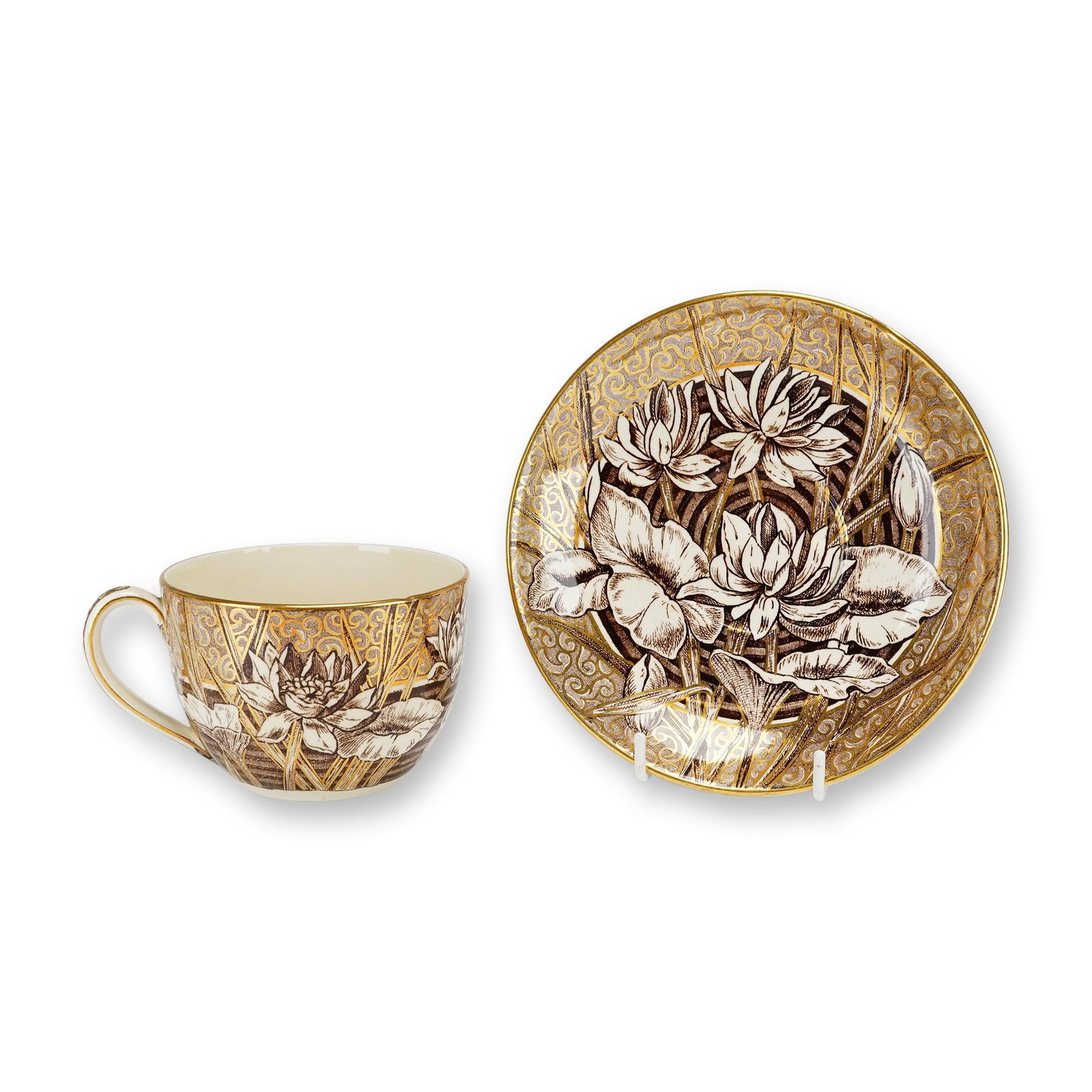 2pc Wedgwood Aesthetic Movement Lilly Pattern Cup and Saucer: This creamware cup and saucer set features the Lilly pattern produced by Wedgwood during the late 19th century Aesthetic Movement. The design depicts brown transfer-printed water lilies and pads over