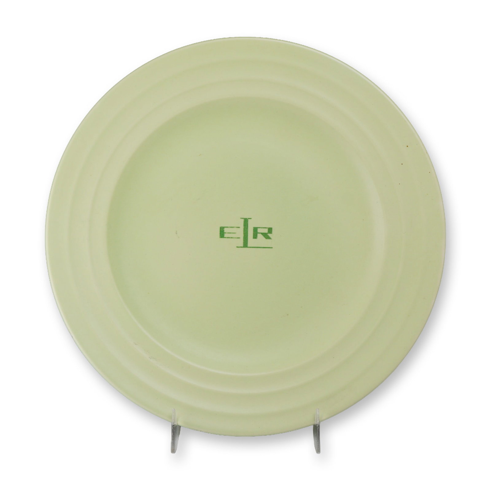 Wedgwood Etruria April Green Art Deco Earthenware Plate with ER Monogram: This circular earthenware plate was manufactured by Wedgwood at the Etruria works in England. Part of the April Green line, the piece is finished in a characteristic matte pale green glaze. The