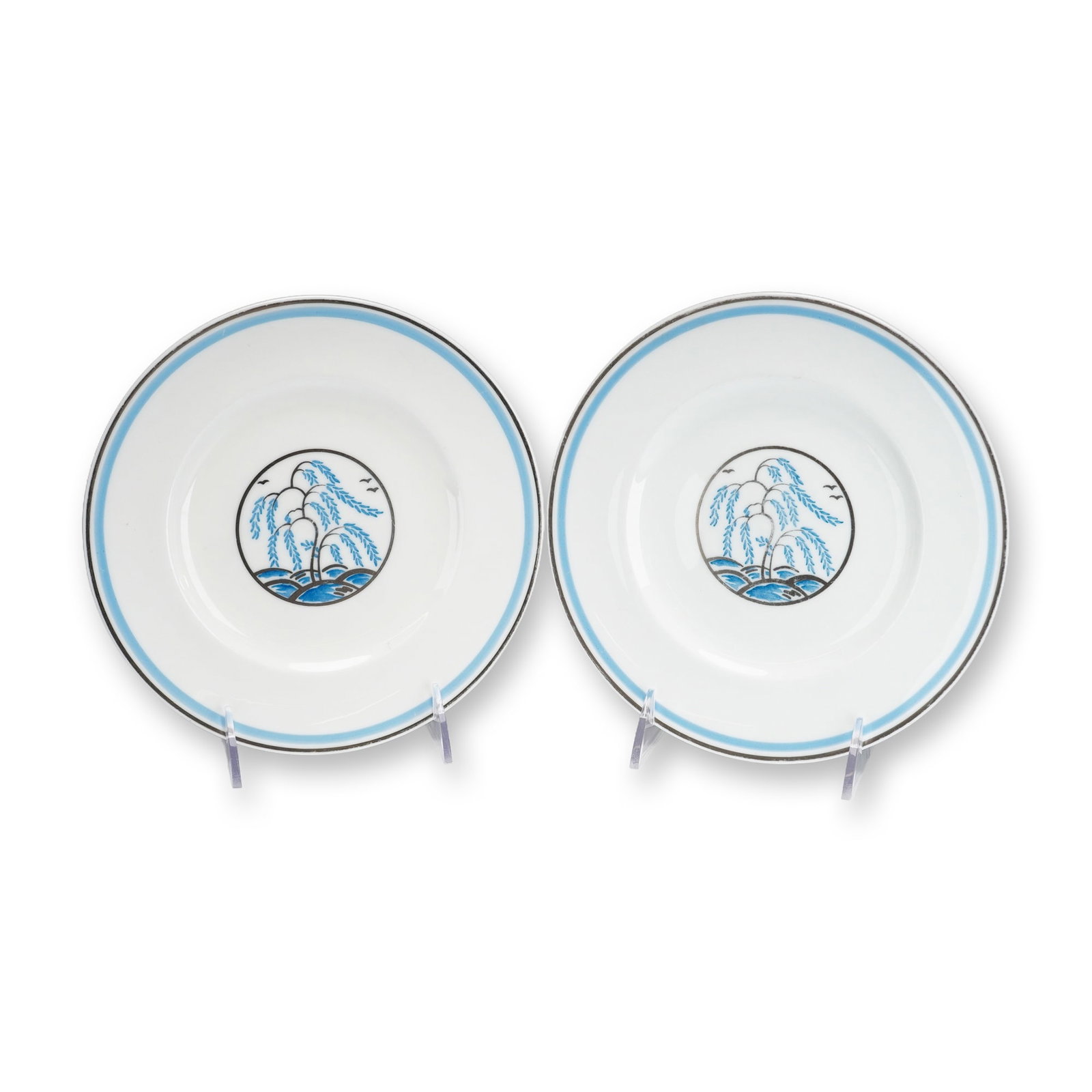 Pair of Wedgwood Plates with Stylized Willow Decoration: A pair of Wedgwood fine bone china plates featuring a modernist take on traditional oriental motifs. Each circular white plate is decorated with a hand-painted central medallion depicting a stylized