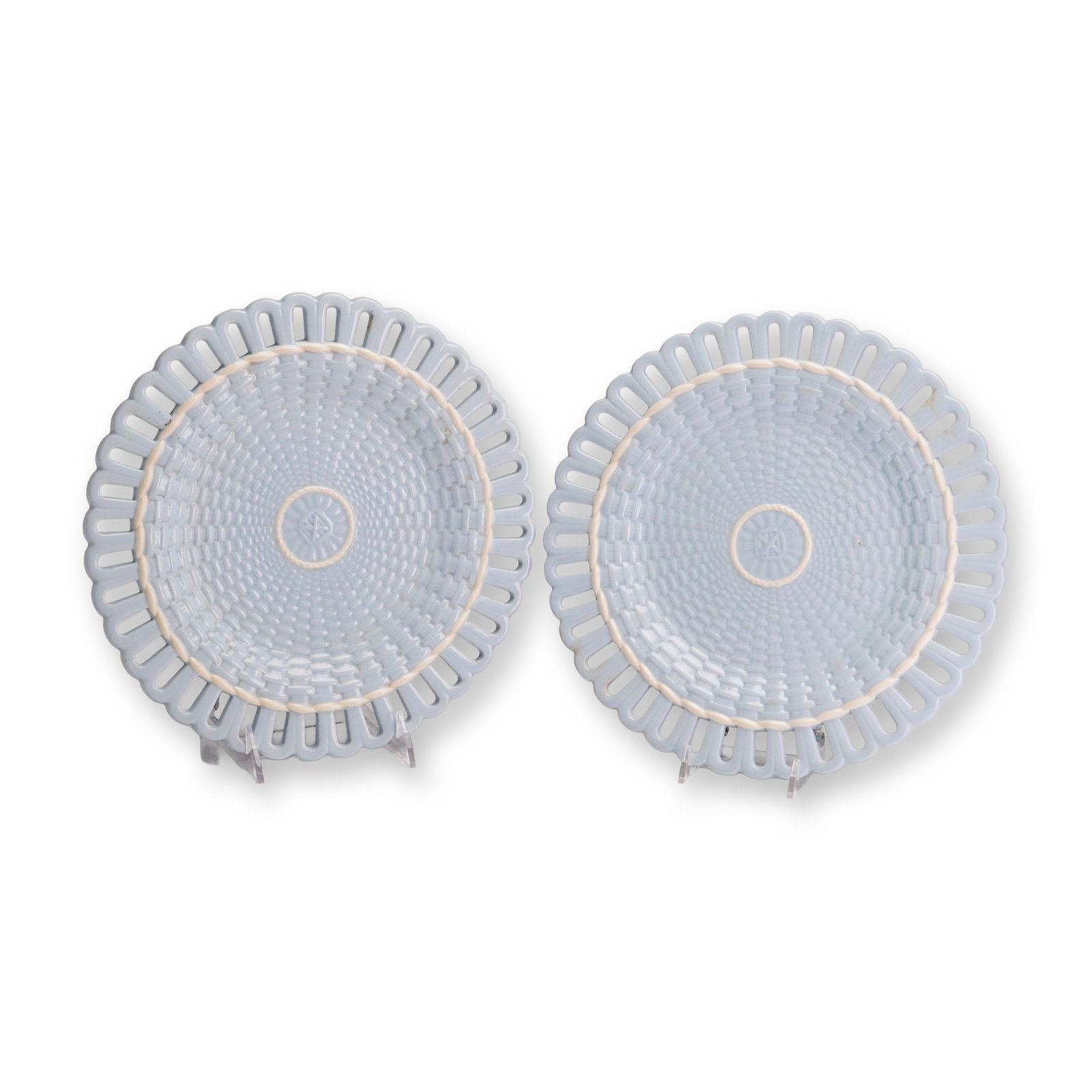 Pair of Wedgwood Blue Basketweave Creamware Plates: A pair of Wedgwood creamware plates featuring a relief molded basketweave pattern across the central well. Each plate is finished in a uniform light blue glaze. The design incorporates a reticulated