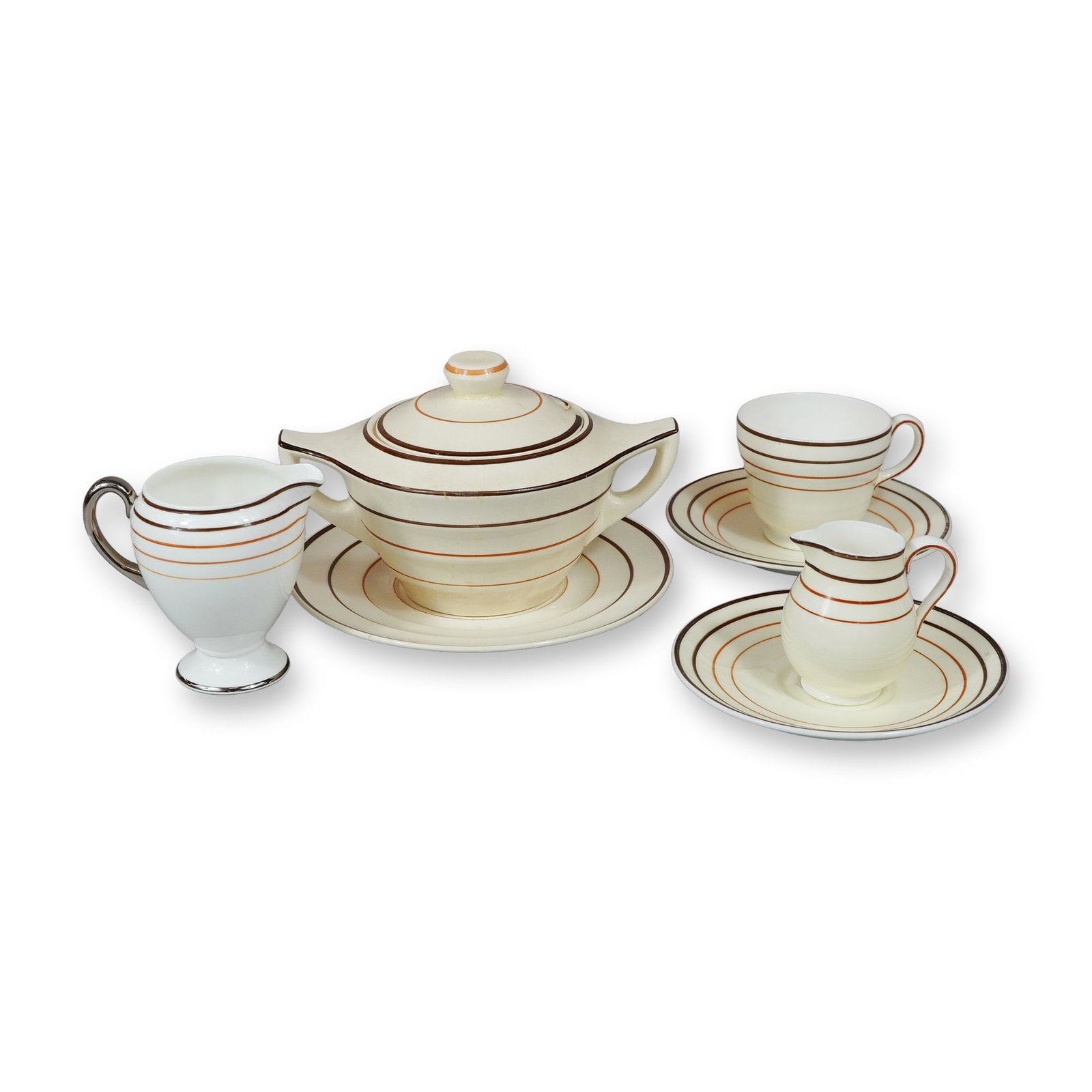 7pc Wedgwood Bone China Art Deco Tableware: This is an assembled collection of Wedgwood bone china. The pieces are characterized by a streamlined, stepped silhouette and horizontal banded decoration in dark brown and tan or orange colors. The