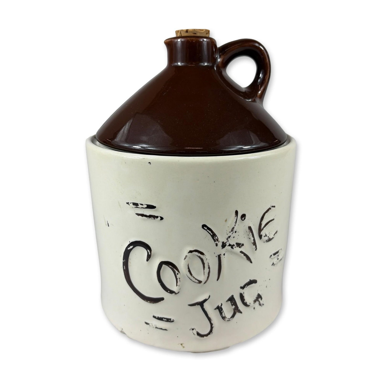 McCoy Pottery Jug Cookie Jar: Mid-20th century novelty lidded cookie jar by McCoy, designed in the form of a traditional shoulder jug. The two-piece construction features a cylindrical cream-glazed body decorated with black styliz