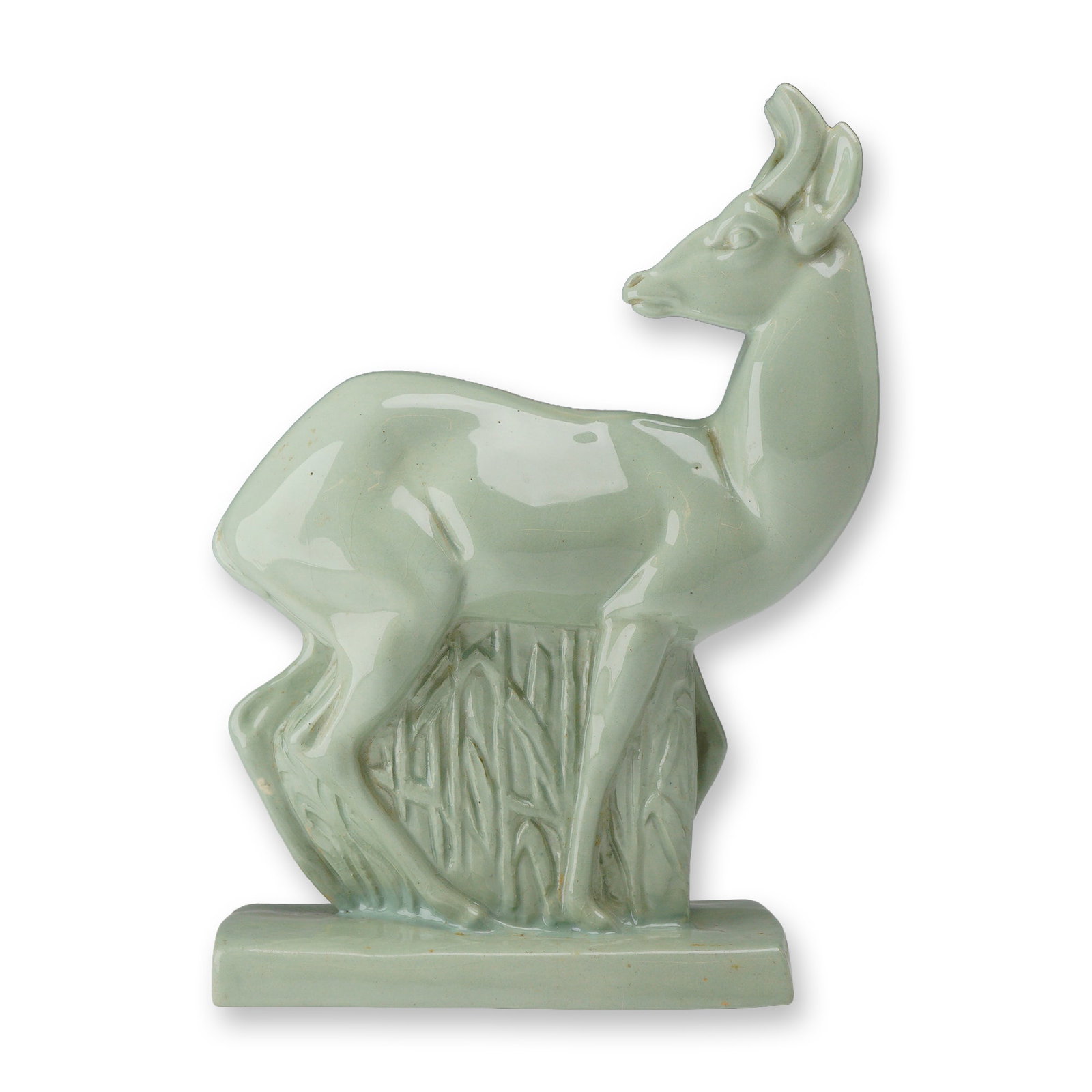 Wedgwood by John Skeaping Art Deco Celadon Glazed Figurine, Fallow Deer: This ceramic figure is rendered in a stylized manner typical of the 1930s animalier series produced by the company. The deer stands alert on a rectangular plinth with a background of sculpted reeds. T