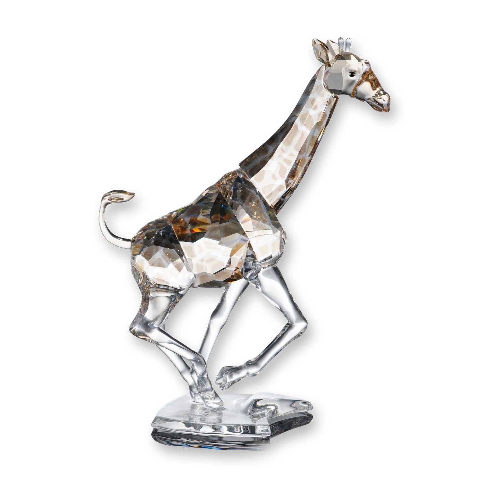 Swarovski Crystal Running Giraffe Figurine: The piece features a clear faceted body with integrated light topaz crystal accents representing the animal's natural markings. Depicted in a dynamic galloping pose with an extended neck and curved ta