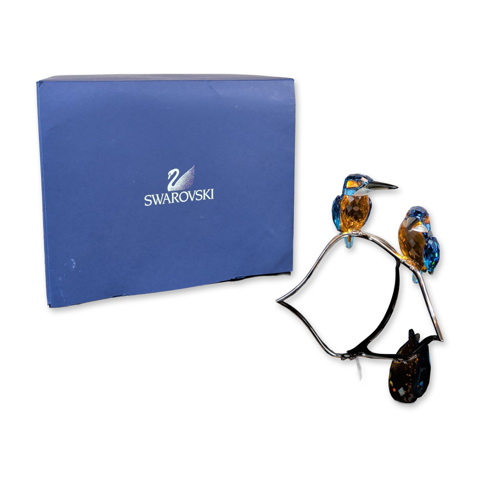Swarovski Crystal Kingfishers on Branch Figurine: Swarovski crystal figurine from the Paradise Birds collection depicting two kingfishers perched on a silver-toned metal branch. The birds are crafted with faceted blue and amber lead crystal bodies, b