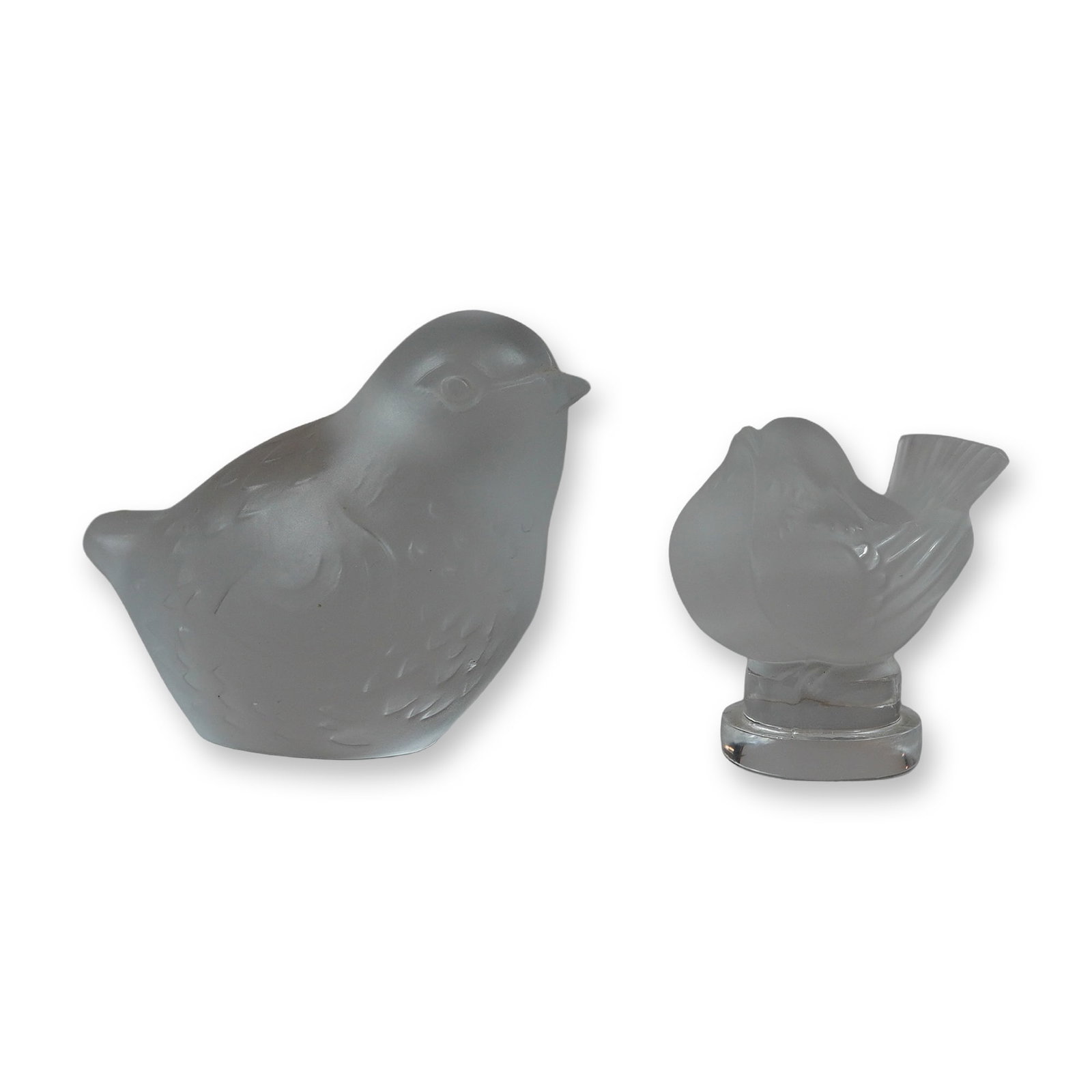 Lalique and Baccarat French Frosted Crystal Bird Figurines: Pair of French frosted crystal bird figurines, featuring designs by Baccarat and Lalique. The Baccarat figure depicts a stylized, perched sparrow with molded feather detailing in a satin-finished crys