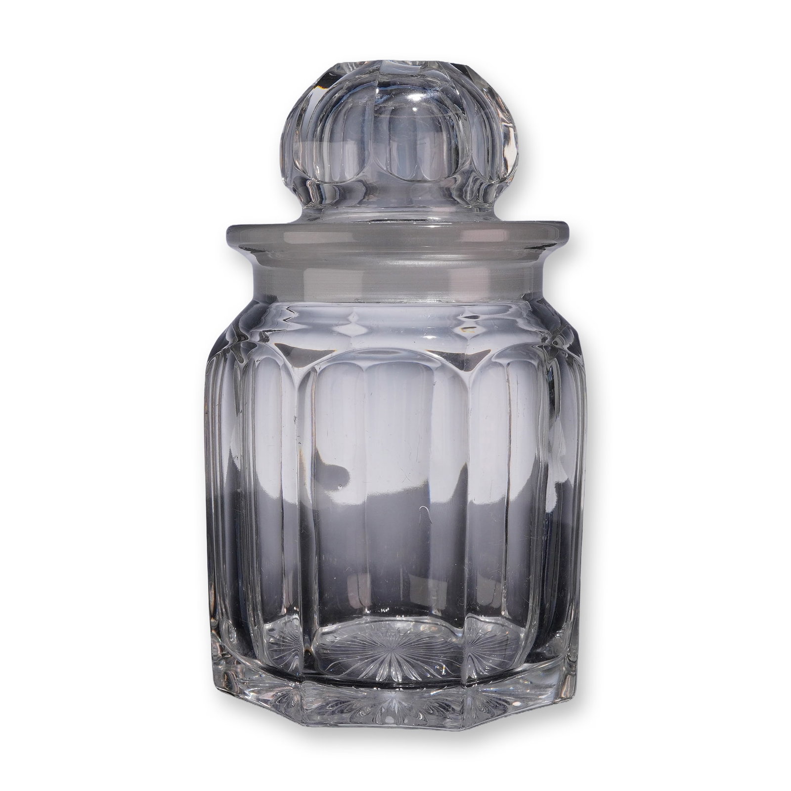 Heisey Crystal Lidded Jar with Star Cut Base: Heisey Glass Company crystal lidded jar. This vessel features an octagonal body with eight vertical fluted panels and arched shoulders. The heavy matching stopper is finished with a globular finial de
