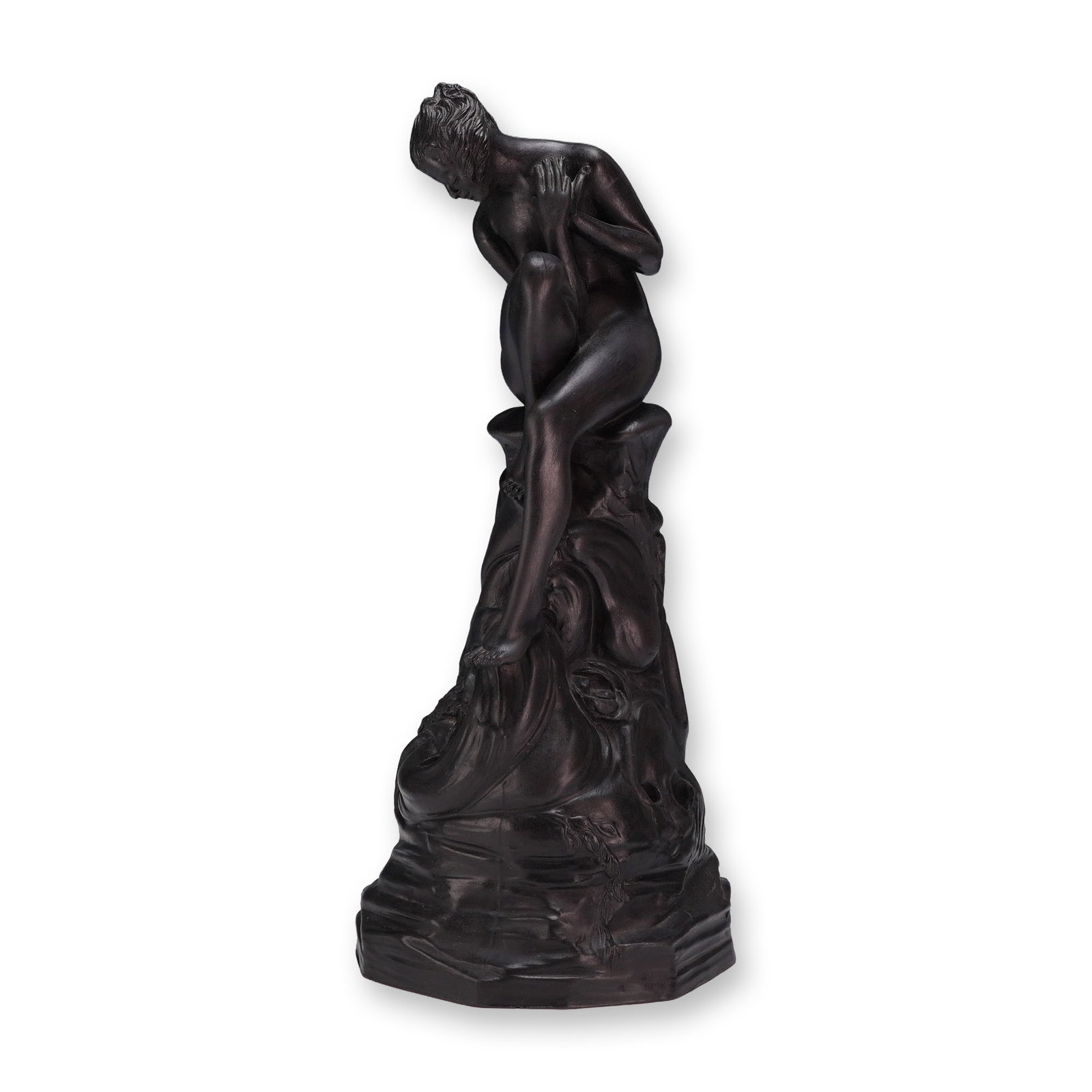 Wedgwood Black Basalt Figure of a Nymph: This Wedgwood black basalt decorative sculpture is modeled as a nude female figure in a pining, contemplative pose, identified as the nymph. The figure is perched atop a tall, rocky base characterized