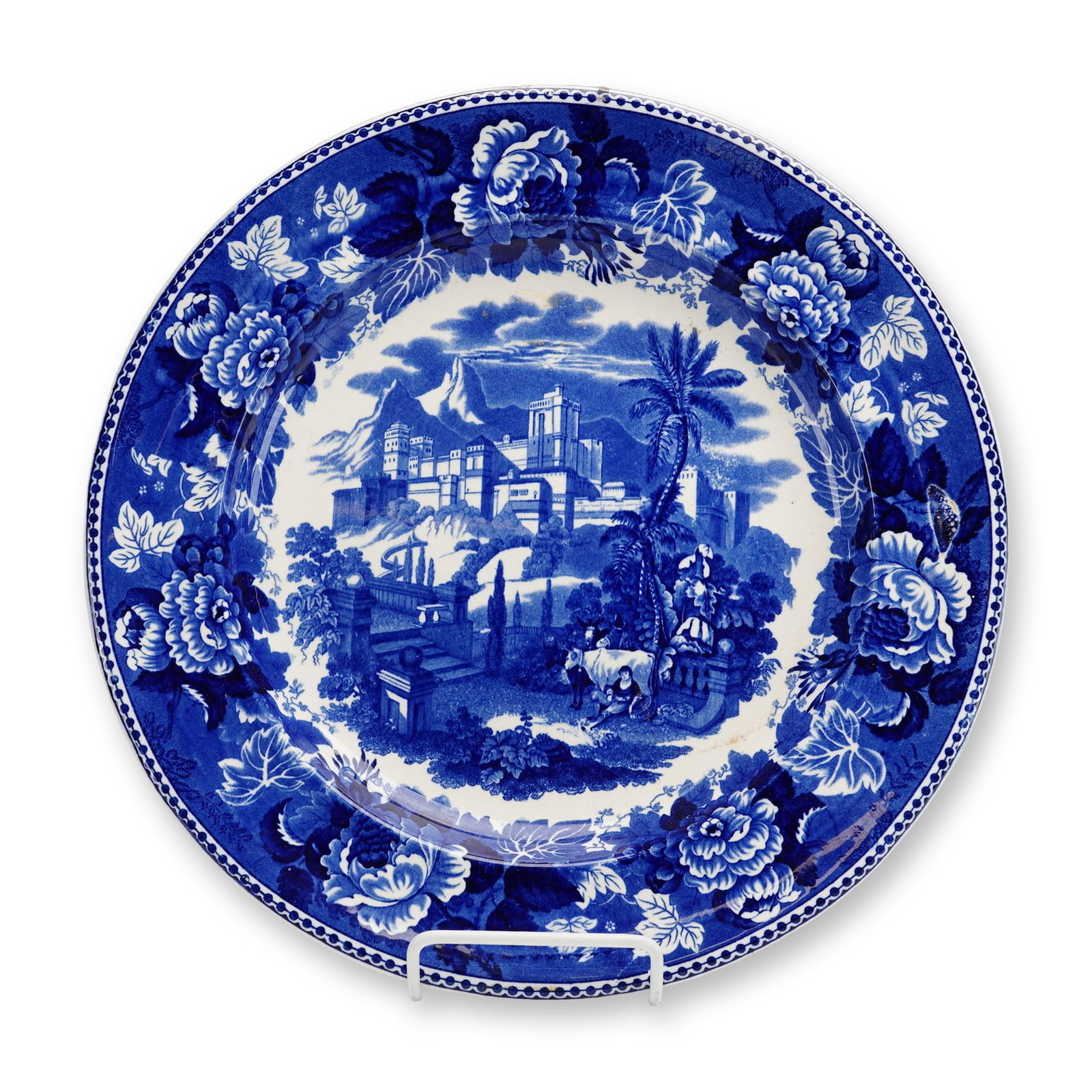 Wedgwood Landscape Blue Plate: This refined Wedgwood transferware plate showcases a captivating and deep blue landscape scene, centered by a pastoral composition of a figure resting against a bull in the foreground. The midground f