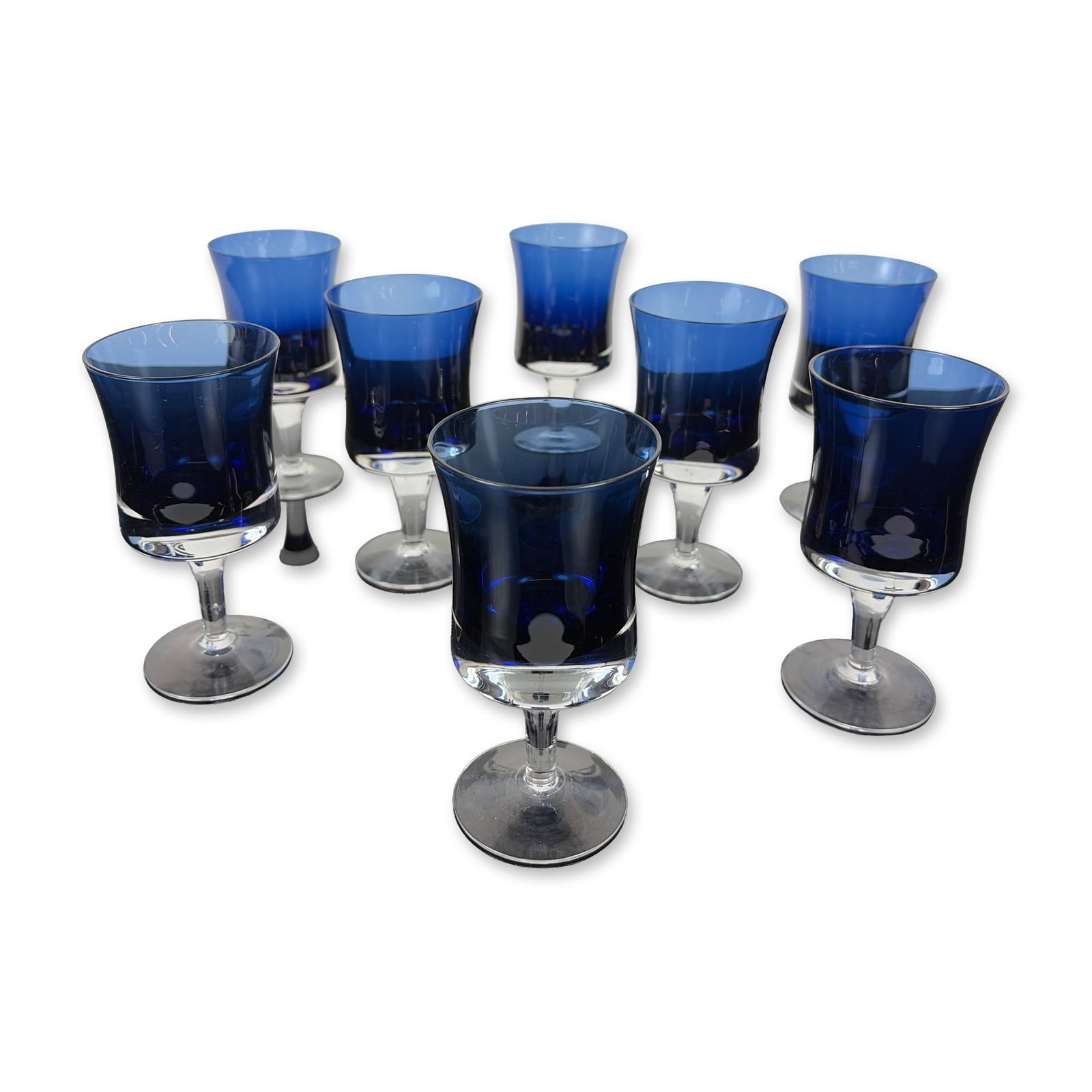 Set of 8 Denby Mirage Blue Crystal Wine Glasses: Each glass features a bell-shaped blue bowl decorated clear crystal stems are and transition to plain circular feet. Dimensions 5.75"H. Dimensions: 5.75"H Weight: 4.10 lbs.