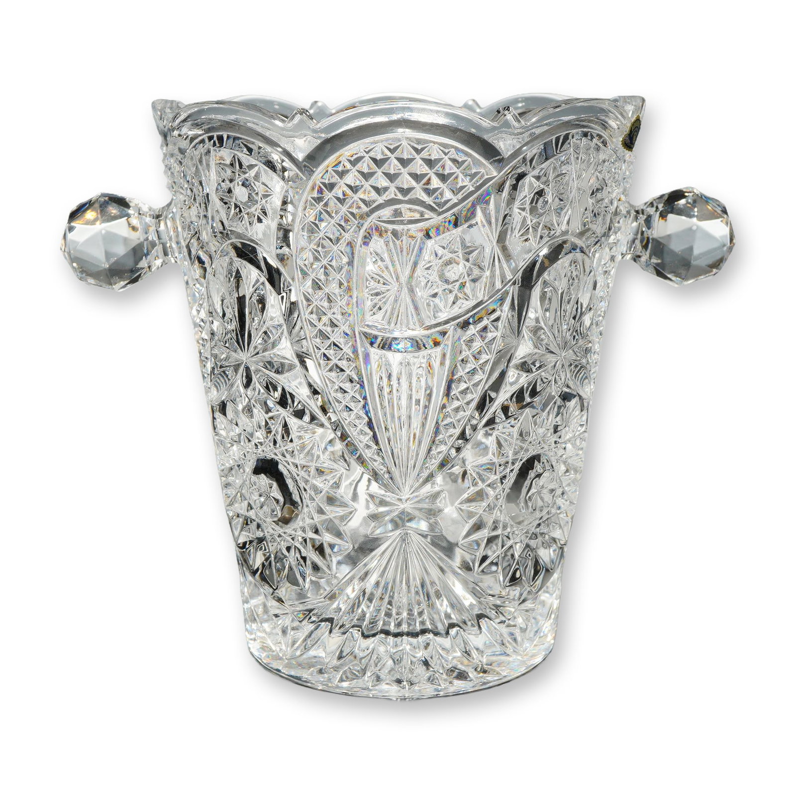Bohemia Cut Lead Crystal Ice Bucket: Bohemia Crystal, Czech Republic. Cut lead crystal ice bucket featuring a flared scalloped rim and two applied faceted knob handles. The vessel is decorated with a complex pattern of deep-cut pinwheel 