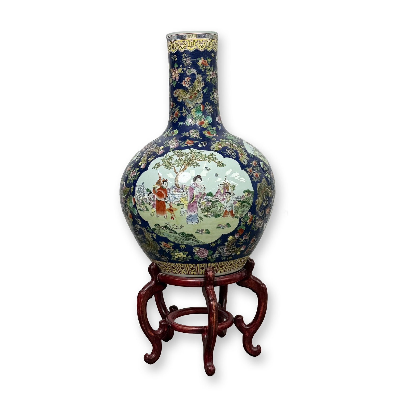 Monumental Qing Style Chinese Porcelain Vase with Stand: Late Qing Dynasty or Republic period. Monumental Chinese porcelain vase in the tianqiuping style, decorated with Famille Rose enamels on a cobalt blue ground. The body features two large lobed cartouc