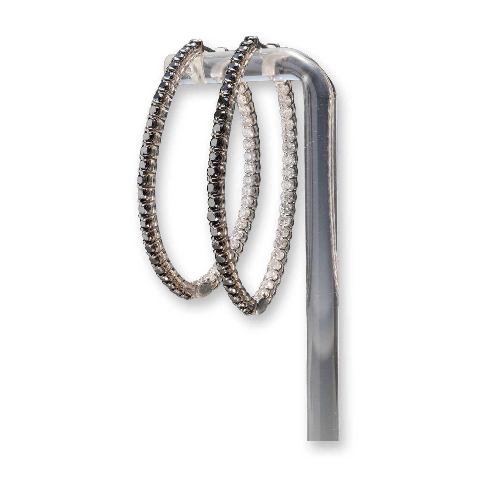 Pair of 14K White Gold 2.77ctw Black & White Diamond Oval Hoop Earrings: A striking pair of 14K white gold oval hoop earrings set with a total of 2.77 carats of round black and white diamonds. The distinctive design features contrasting stones, with black diamonds adorning