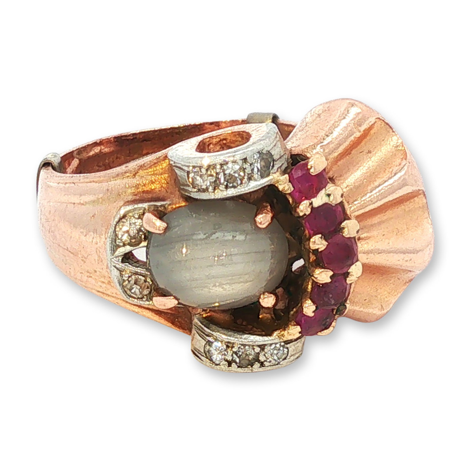 Retro 14K Gold Ruby Diamond and Star Sapphire Ring: Retro style cocktail ring, circa 1940s, crafted in 14K rose and white gold. The central setting features one oval cabochon milky star sapphire showing a distinct star effect. One side is accented with