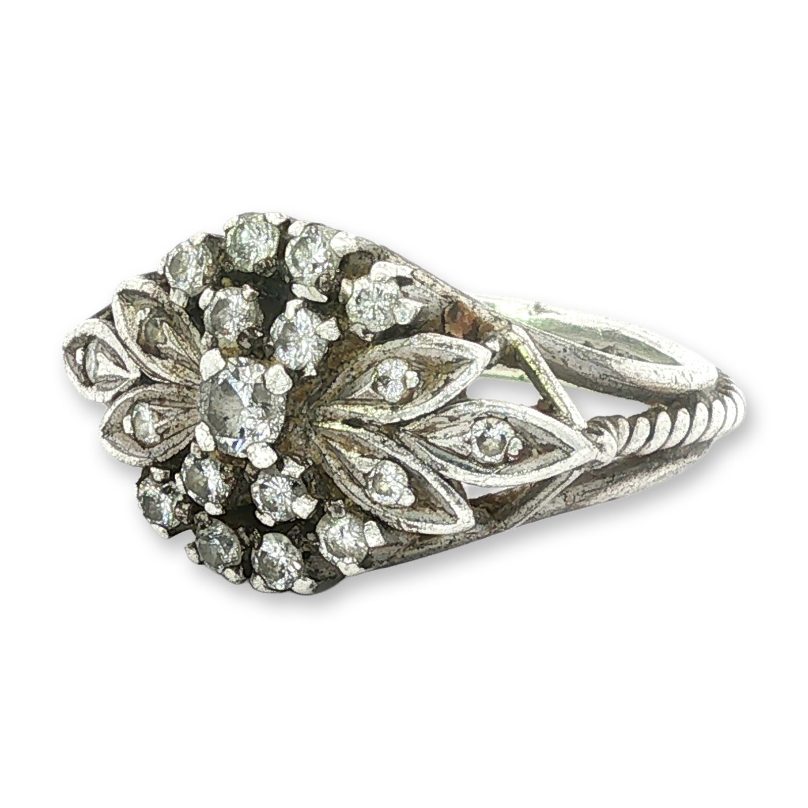 Silver Diamond Floral Cluster Ring: A vintage-style floral cluster cocktail ring in silver. The marquise-shaped face is composed of a central round-cut clear diamond surrounded by 12 smaller round-cut diamonds. The centerpiece is embell