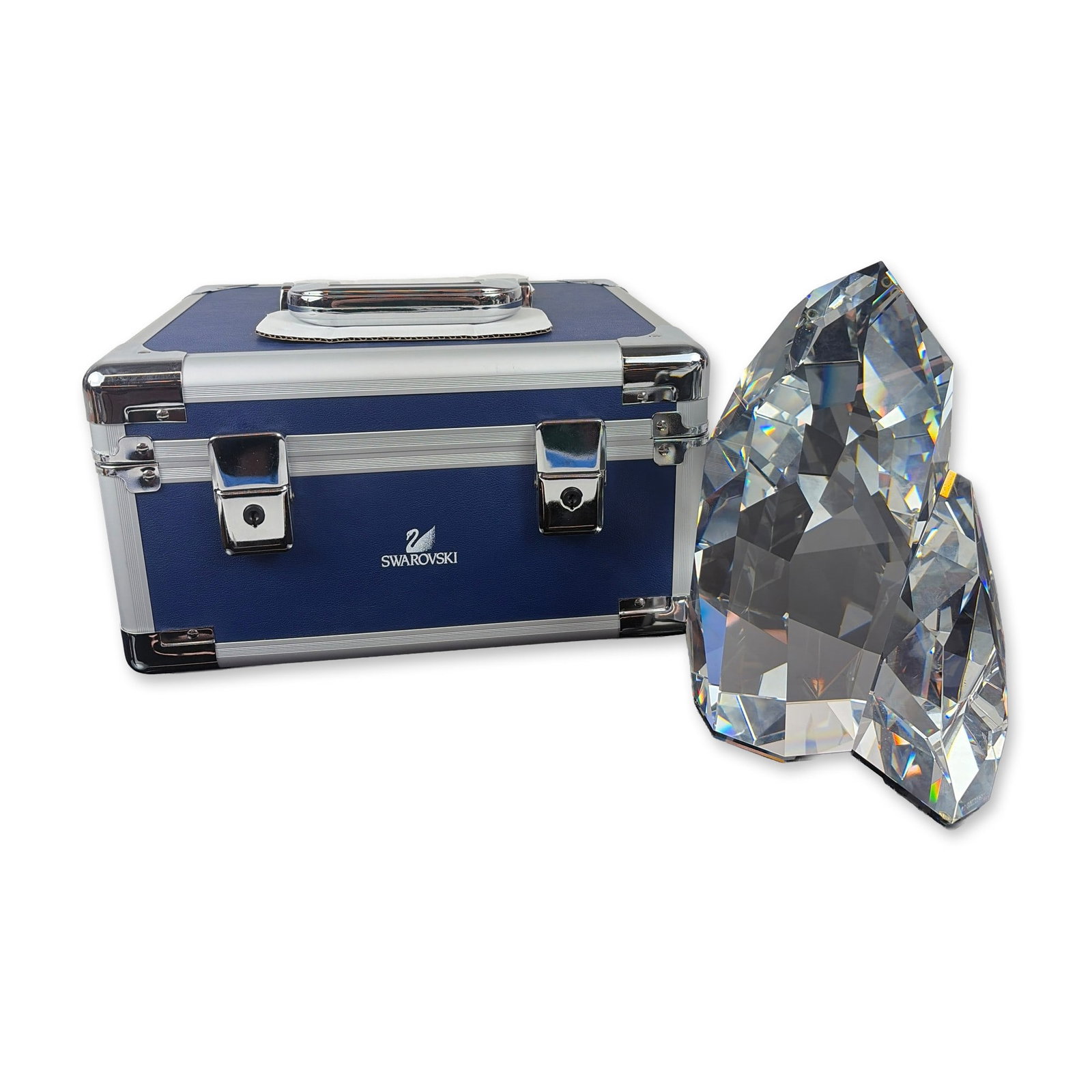 Swarovski Limited Edition Iluliac Iceberg Crystal Sculpture: Swarovski faceted lead crystal sculpture titled Iluliac Iceberg, featuring an abstract, multi-faceted form designed to maximize light refraction and spectral display. The crystal is etched with editio