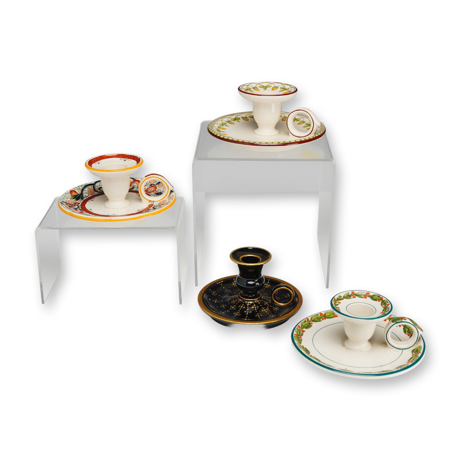 4pc Wedgwood Earthenware Chambersticks: This collection consists of four earthenware chambersticks manufactured by Wedgwood at the Etruria factory. Each piece features a traditional finger-hold form with a wide saucer base, a central candle