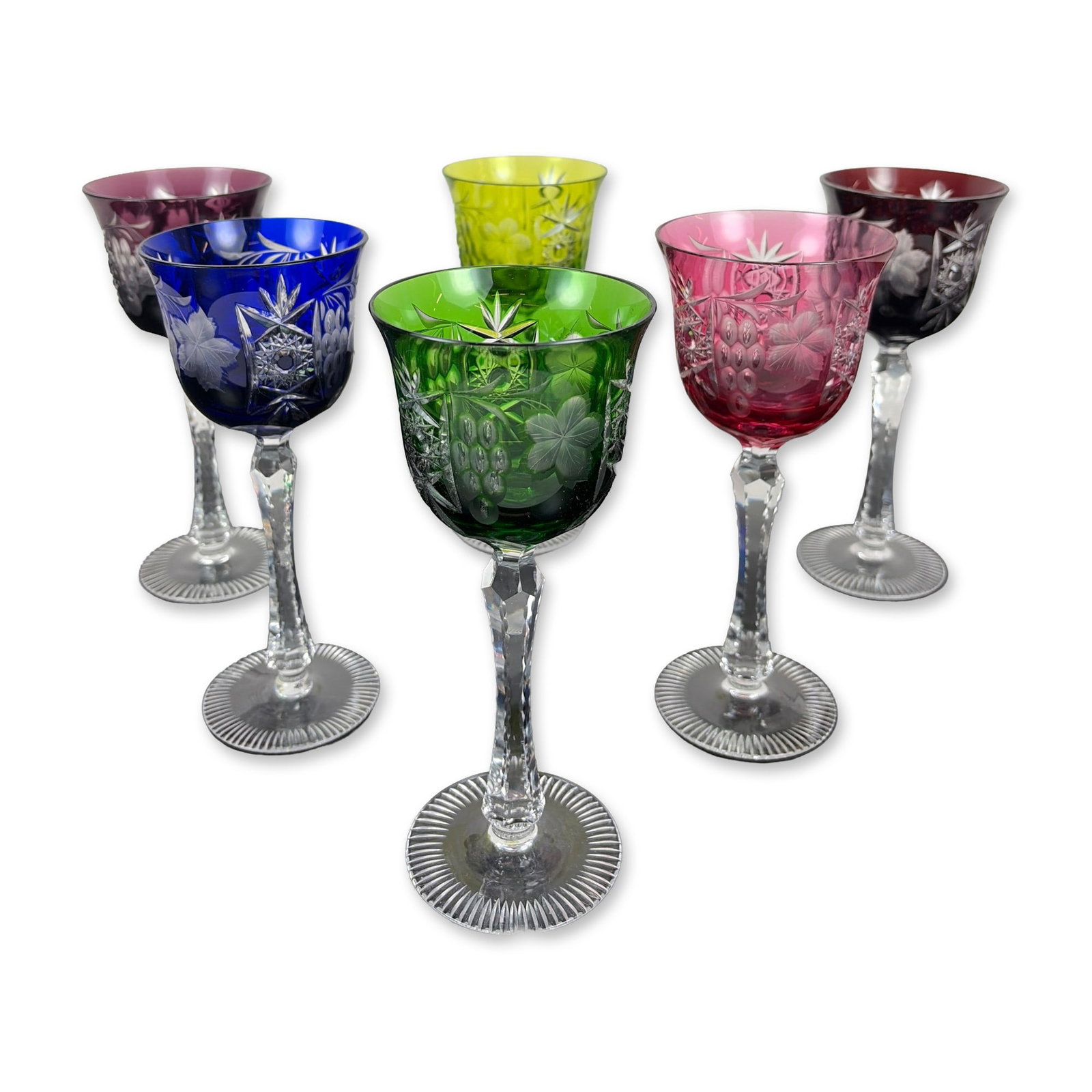 Set of Six Cut-to-Clear Crystal Wine Goblets: Bohemian style set of six hock glasses in cased-to-clear lead crystal. The harlequin collection features one glass each in ruby, cranberry, emerald, chartreuse, cobalt, and amethyst. The bowls are dec