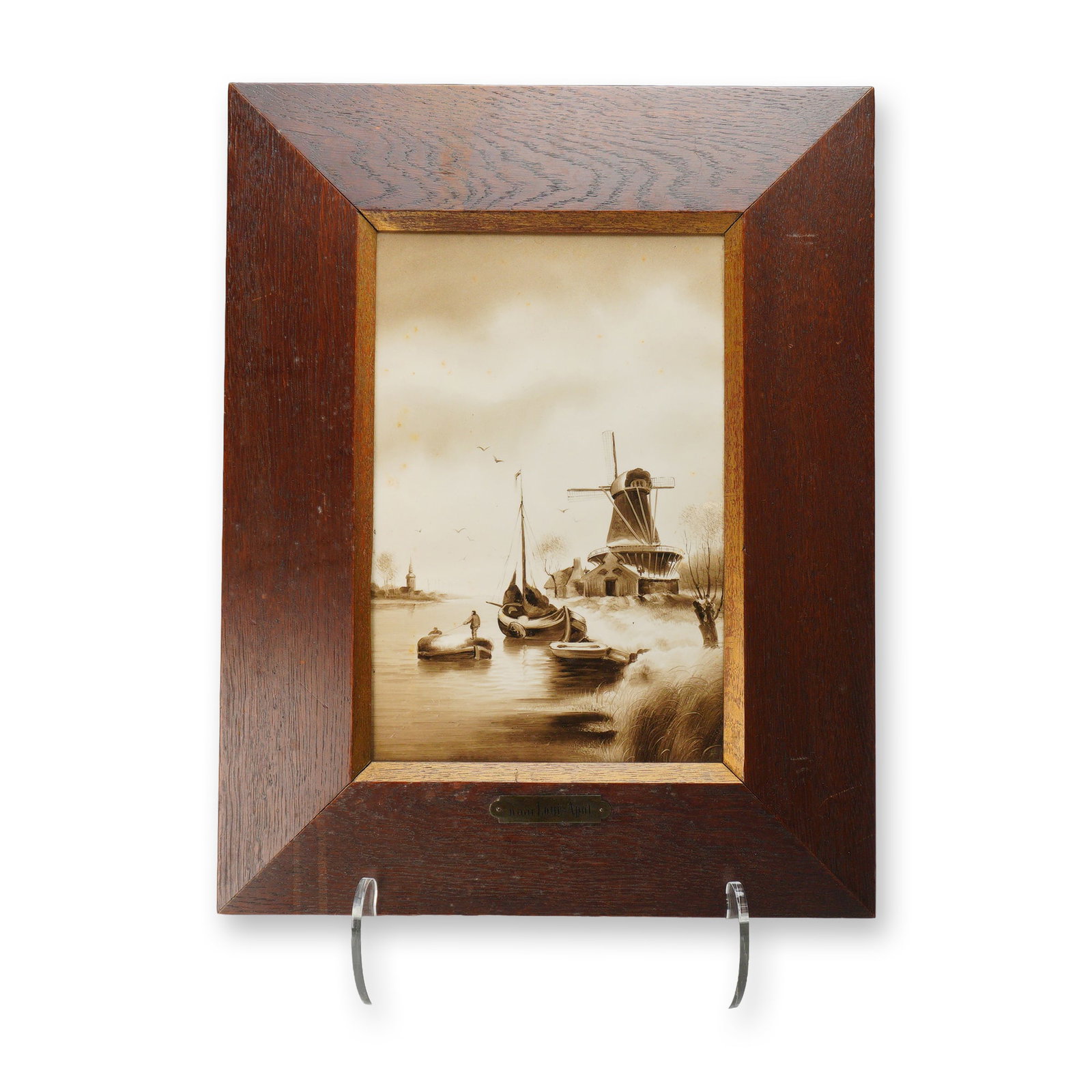 After Louis Apol (Dutch, 1850-1936) Sepia Oil on Plaque, Dutch Winter Landscape with Windmill: This monochromatic sepia-toned painting, executed in oil on a smooth ceramic plaque or panel, depicts a traditional Dutch winter landscape in the style of the Hague School. The composition features a 