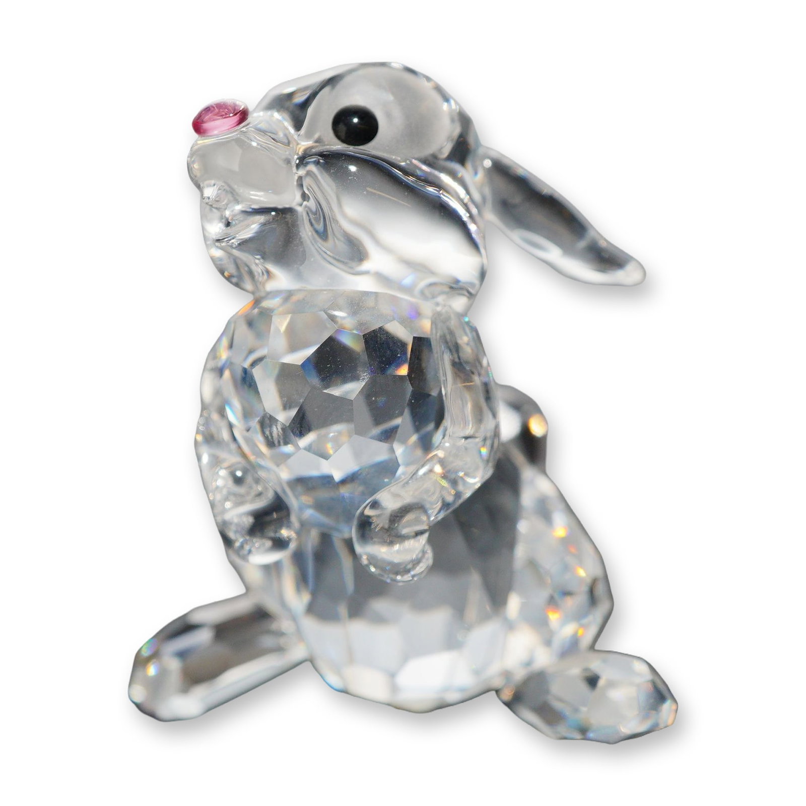 Swarovski Crystal Thumper Rabbit Figurine: Swarovski lead crystal figurine depicting the character Thumper. The piece features a faceted lower body and tail with a smooth molded head and ears. Details include applied black eyes and a small