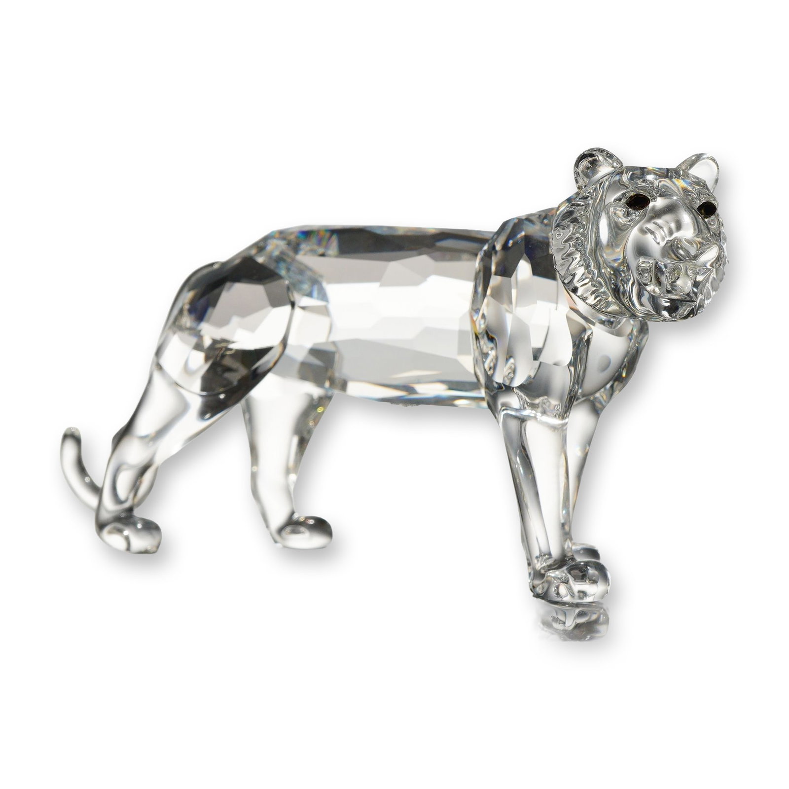 Swarovski Crystal Endangered Species Tiger Figurine: Swarovski clear crystal tiger figurine from the Endangered Species collection. The lead crystal figure features a faceted body and upper haunches, with smooth molded legs and an upward-curving tail. T