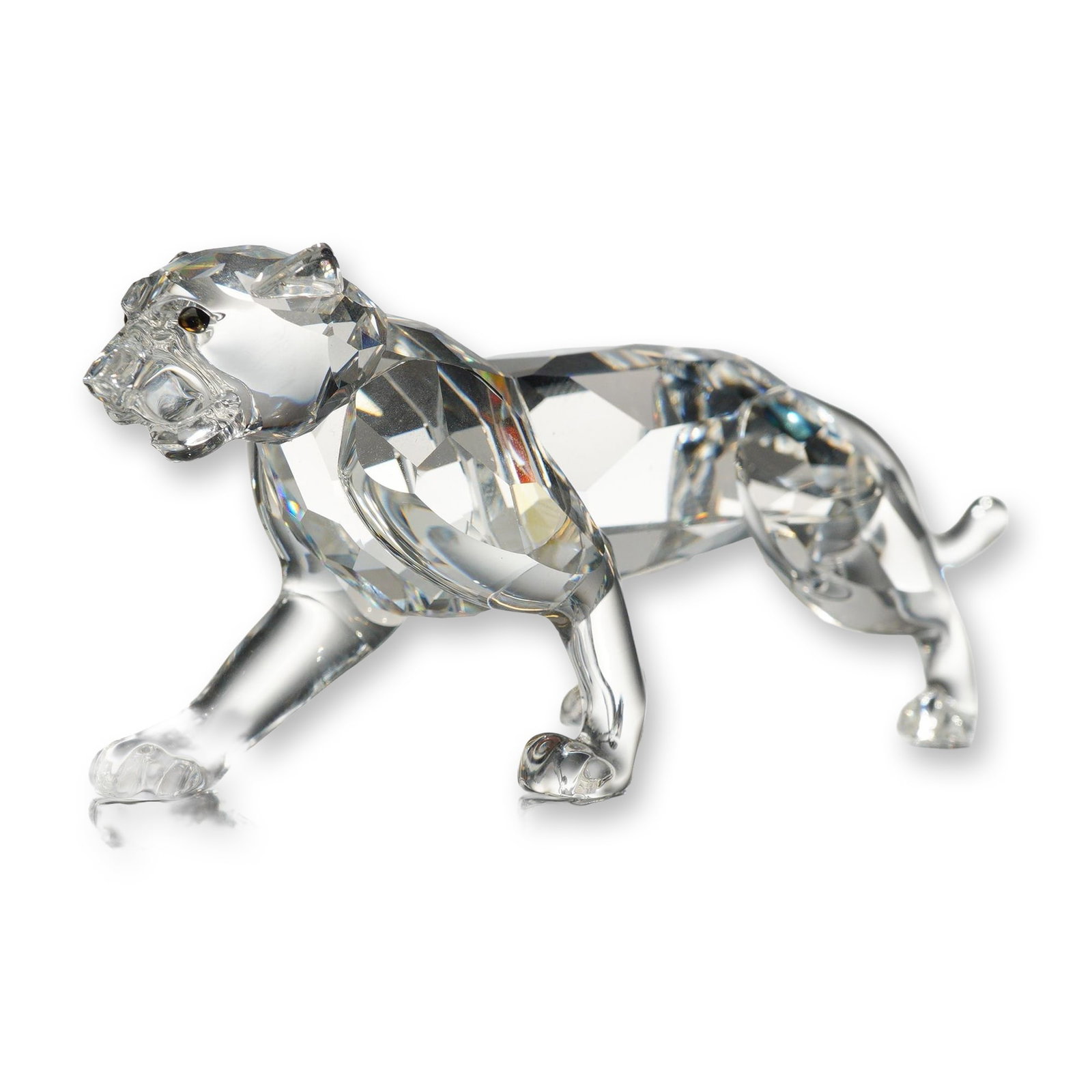 Swarovski Crystal African Wildlife Leopard Figurine: Swarovski Silver Crystal lead crystal figurine depicting a stalking leopard from the African Wildlife series. The figure is crafted with a highly faceted clear crystal body and head, featuring smooth 