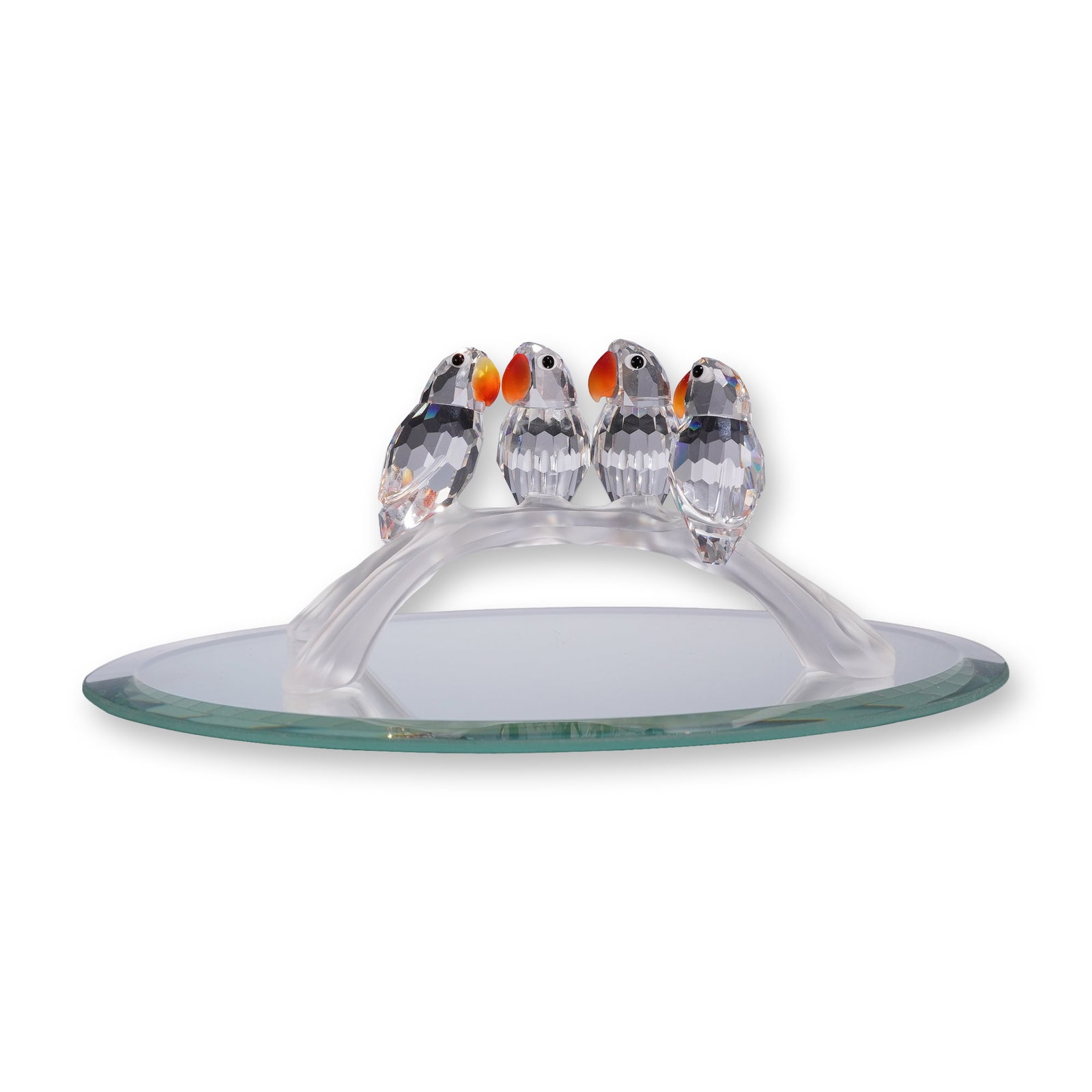 Swarovski Crystal Baby Lovebirds Figurine: Swarovski crystal figurine titled Baby Lovebirds, model number 199123. The piece consists of a group of birds with faceted clear crystal bodies, orange-toned beaks, and black eyes, all perched upon a 
