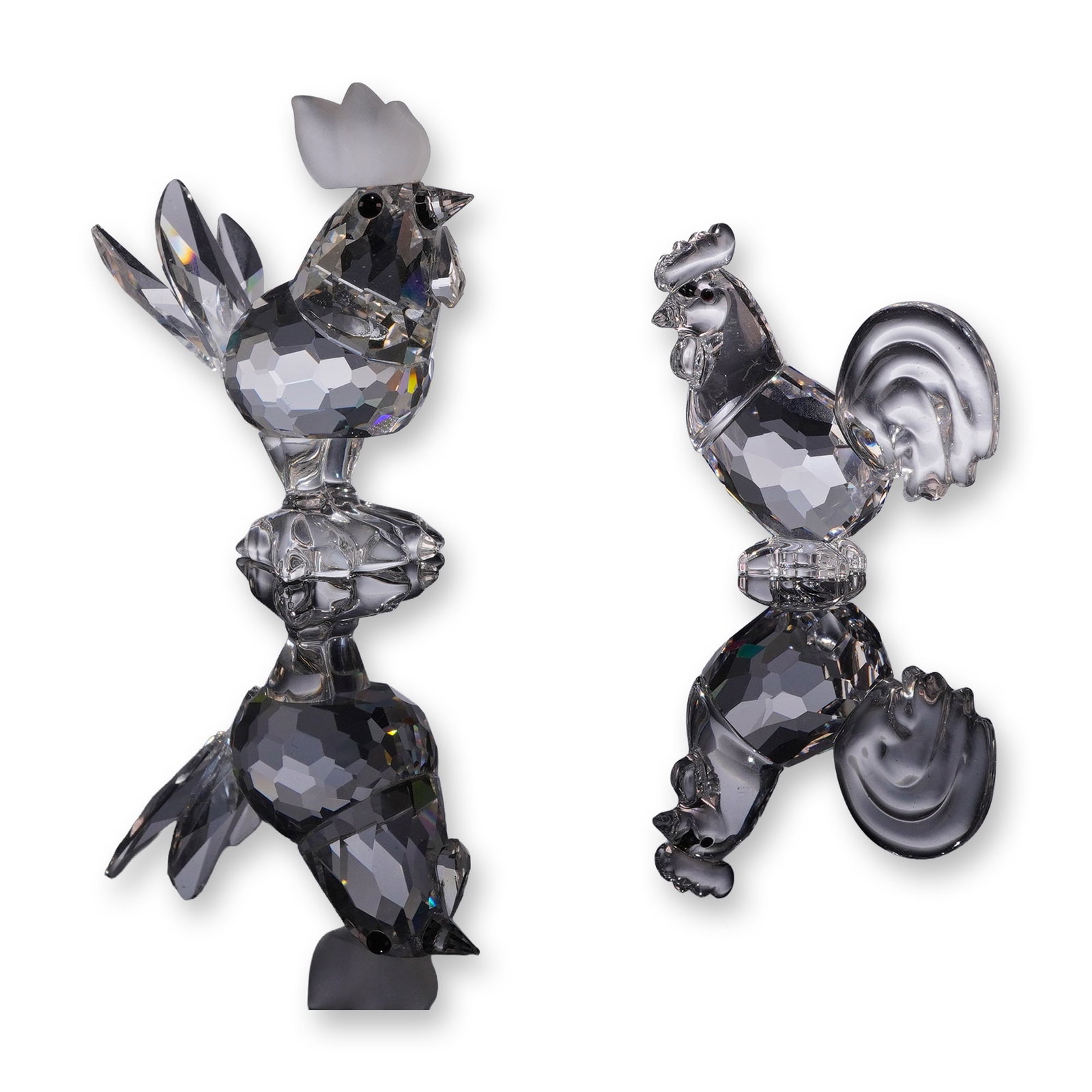 Two Swarovski Crystal Rooster Figurines: Swarovski, Austria. Two faceted lead crystal bird figurines, comprising the Cockerel, model 014497, and the Zodiac Rooster, model 625189. The Cockerel features a frosted crystal comb, black crystal ey