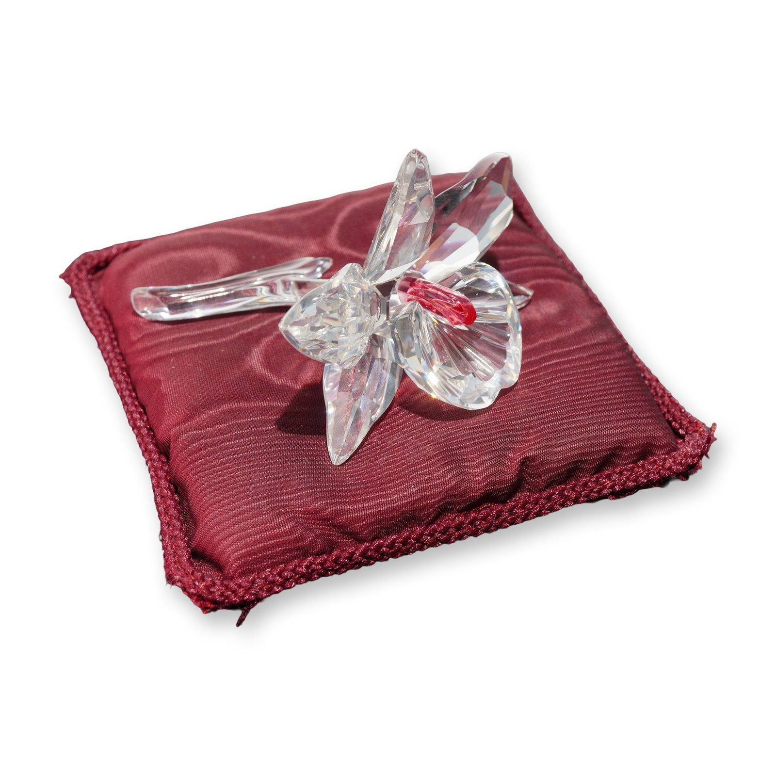 Swarovski Silver Crystal Pink Orchid Figurine: Swarovski. Pink orchid figurine in faceted clear lead crystal, part of the Silver Crystal collection. The stylized blossom features five faceted petals surrounding a central fluted element accented wi