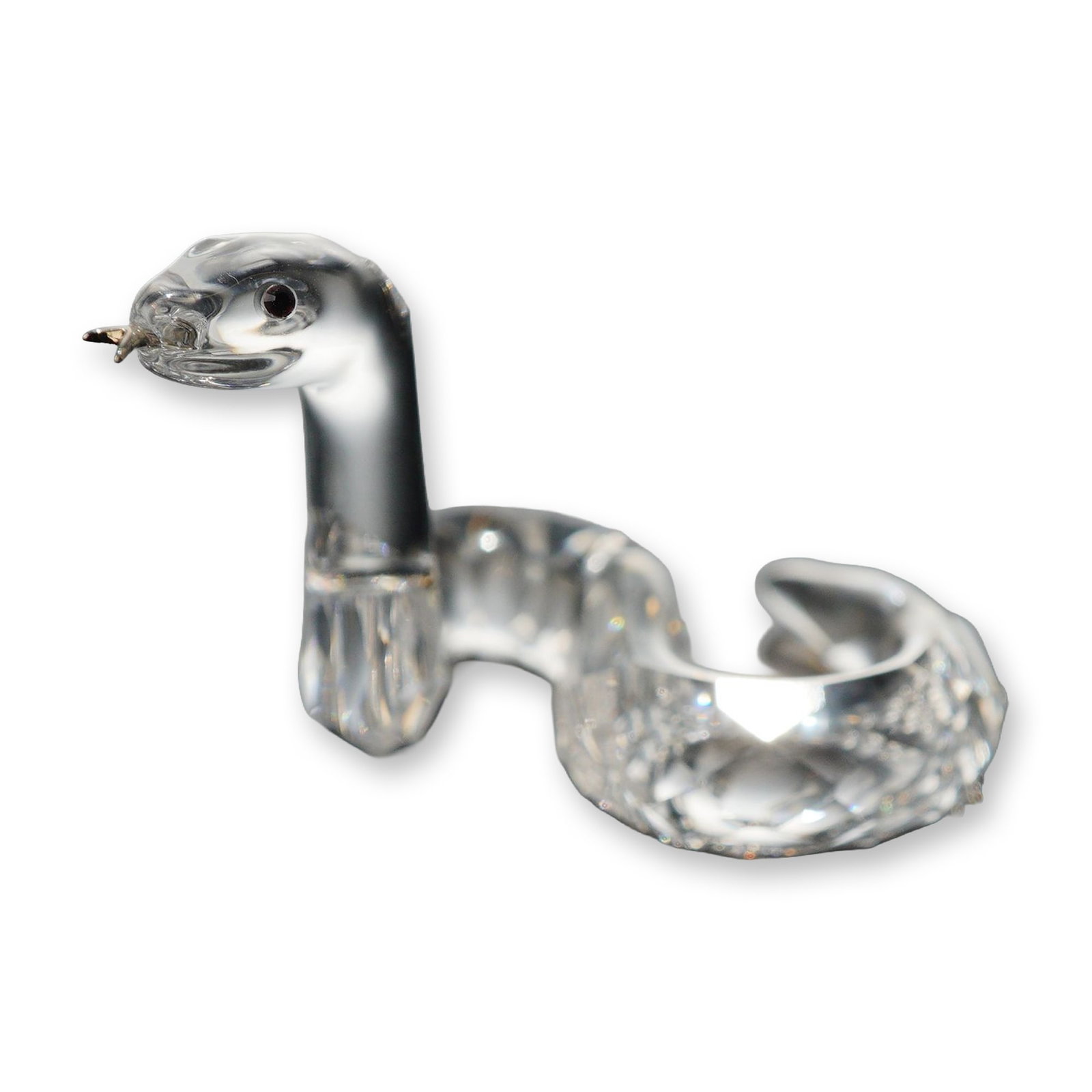 Swarovski Crystal Chinese Zodiac Snake Figurine: Swarovski clear lead crystal Chinese zodiac snake figurine, featuring a faceted coiled body, smooth arched neck, applied black bead eyes, and a metal forked tongue. One of the lower faceted body segme