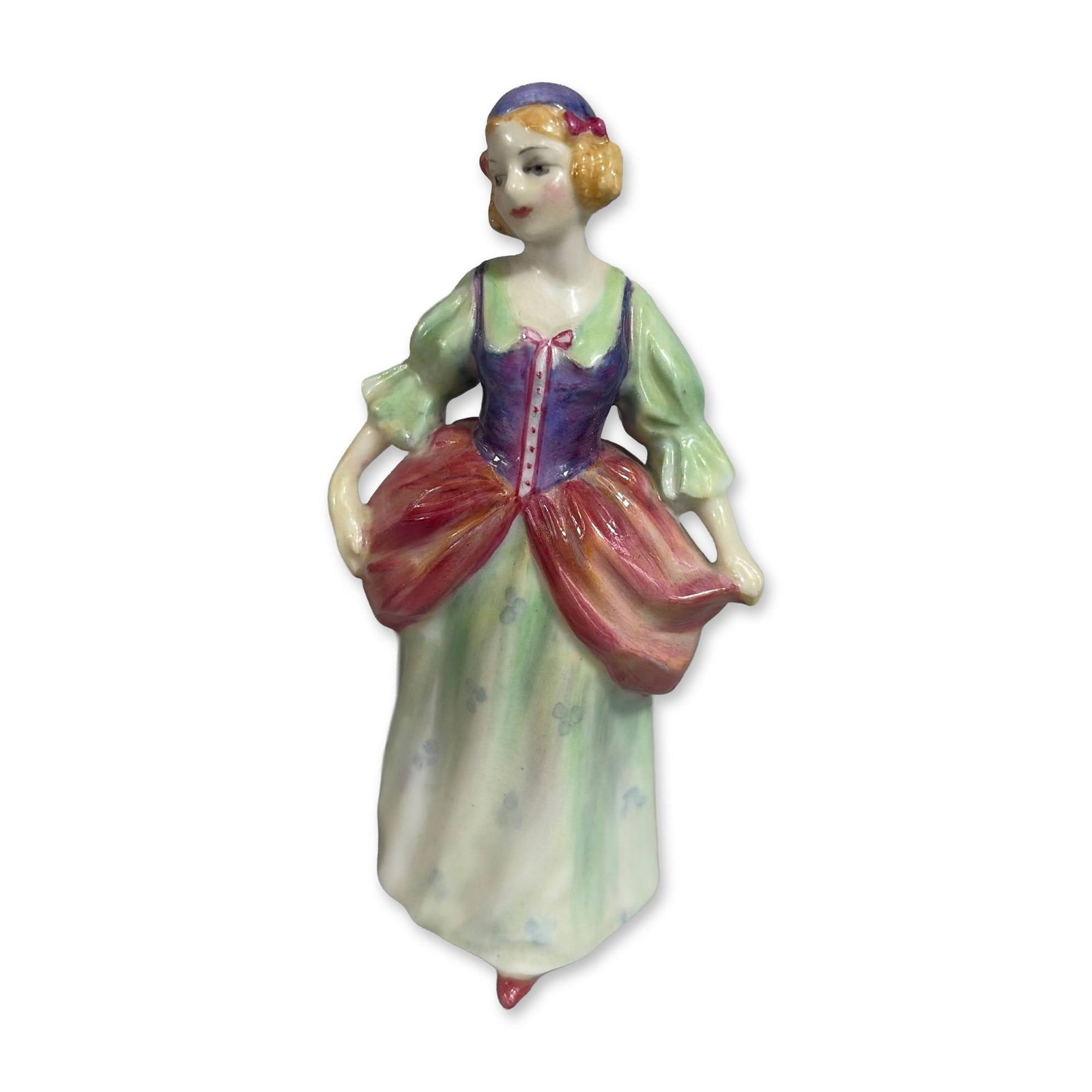 Royal Doulton Denise Miniature Porcelain Figurine M34: Figurine titled Denise, model M34, featuring a young woman in 18th-century style provincial dress. The hand-painted polychrome glazed figure is depicted with a purple bodice and red lacing, puffed gre