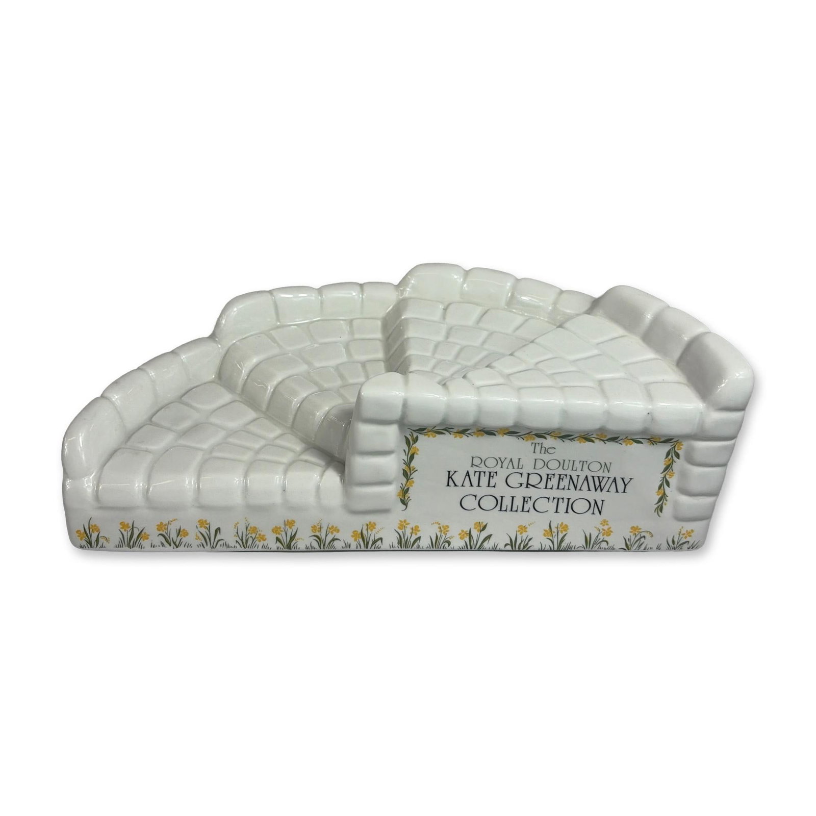 Royal Doulton Kate Greenaway Display Stand: Royal Doulton. Four-tiered figurine display stand from the Kate Greenaway Collection, crafted in glazed white ceramic. The curved, semi-circular structure features tiers molded with a cobblestone or b