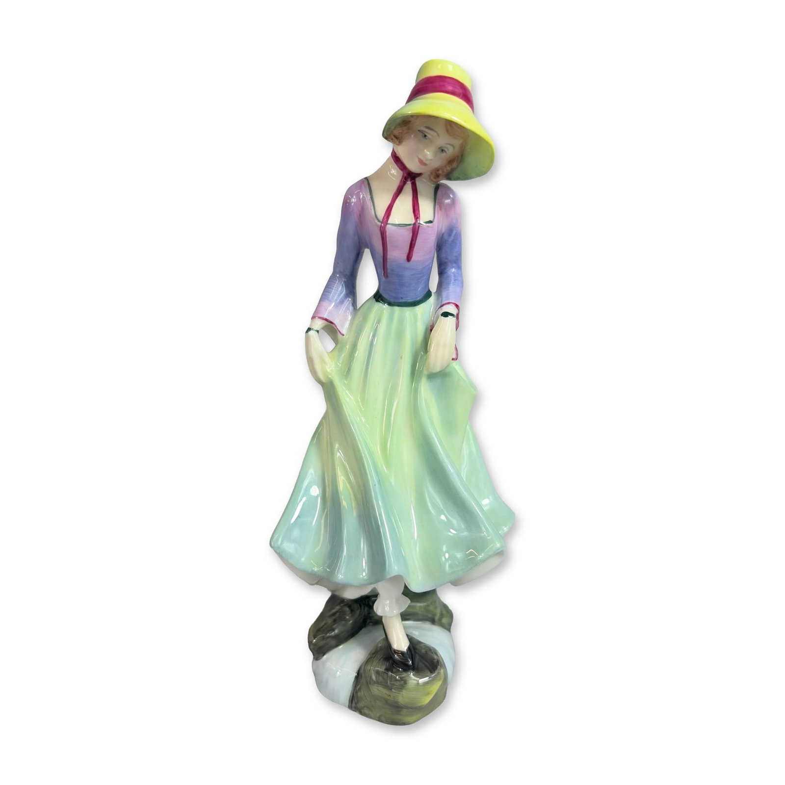 Royal Doulton Polly HN 3178 Porcelain Figurine: Royal Doulton glazed bone china figurine titled Polly, model number HN 3178. Modeled by Douglas V. Tootle and issued in 1988. The figure is depicted in a shaded purple and blue bodice with magenta rib