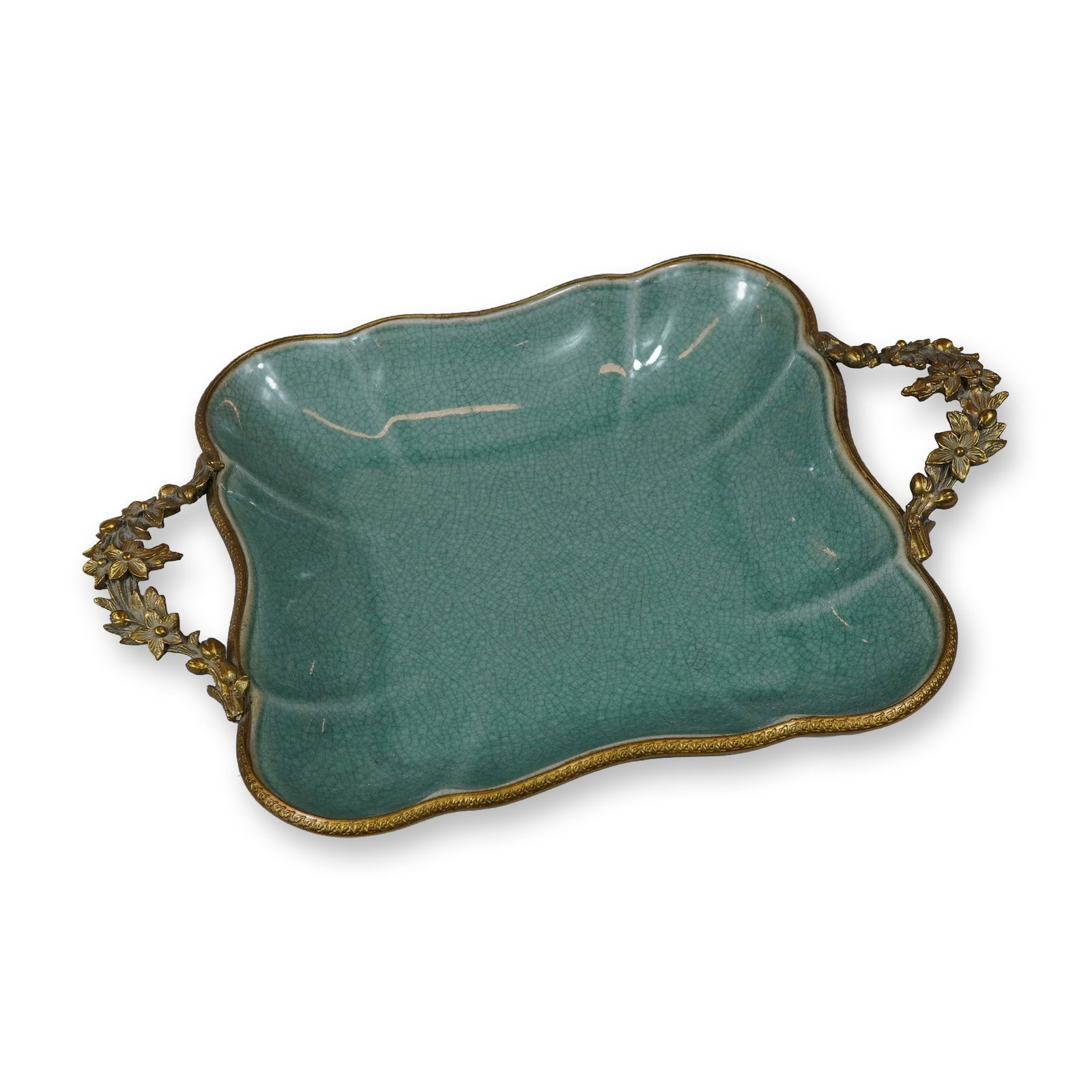 Crackle Glaze Porcelain Centerpiece Dish with Ornate Gilt-Brass Handles: This vintage porcelain centerpiece dish is finished in a turquoise or celadon green crackle glaze. The tray features a scalloped square form with lobed corners and is accented with ornate gilt-brass m