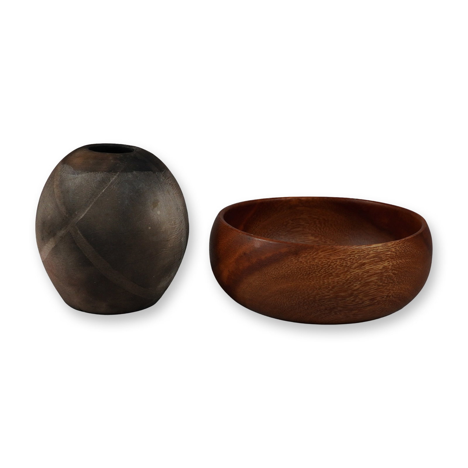 Two Pieces: A Kamani Wood Bowl and a Ceramic Vase: A group of two decorative items comprising a turned wooden bowl and a small smoke-fired ceramic vessel. The wooden bowl is crafted from kamani wood, featuring a rich reddish-brown color with a