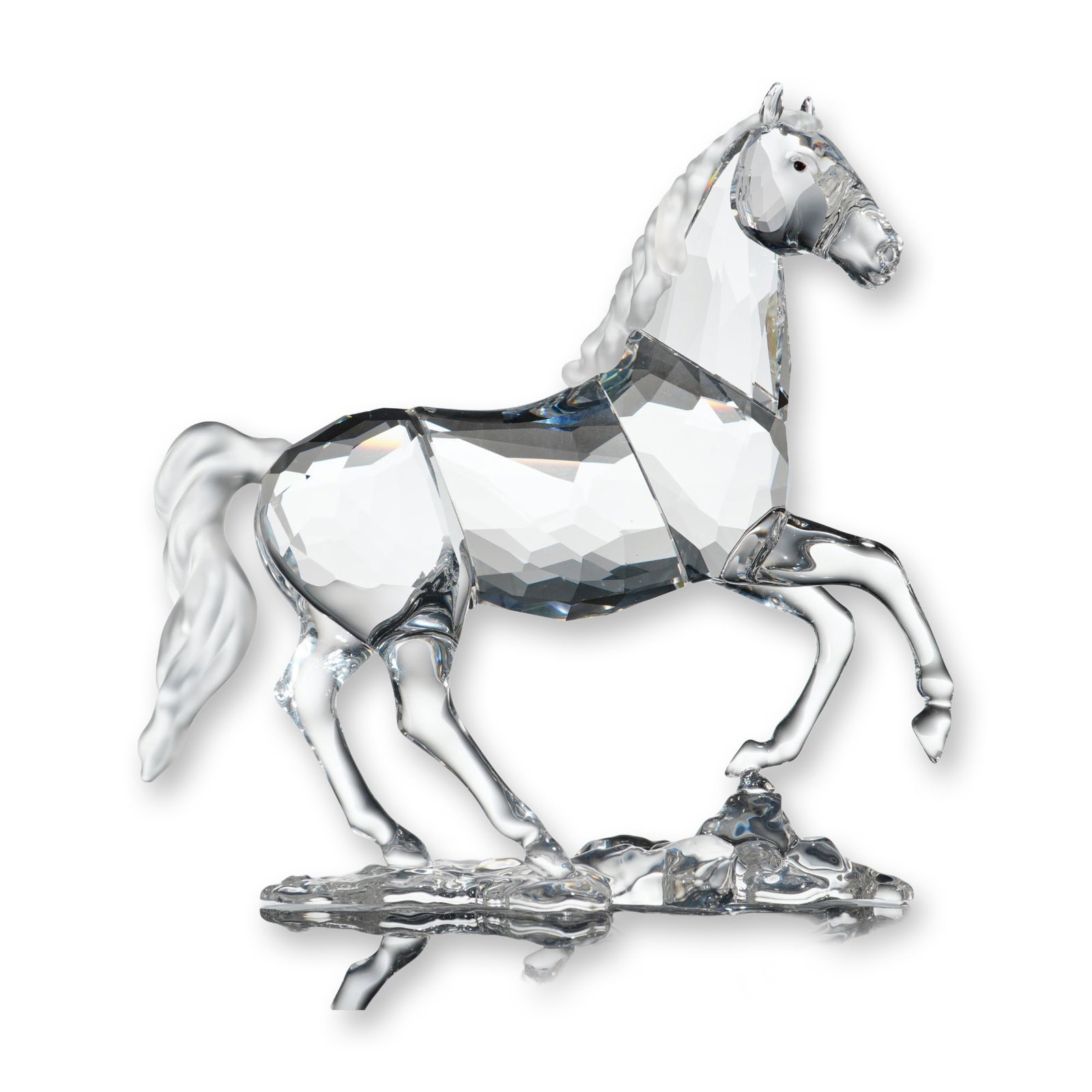Swarovski Crystal Figurine, Stallion with Box: Stallion figurine in clear faceted and frosted crystal, depicting a horse in a dynamic pose on a textured clear crystal base. The body and legs are composed of multifaceted clear lead crystal, while t