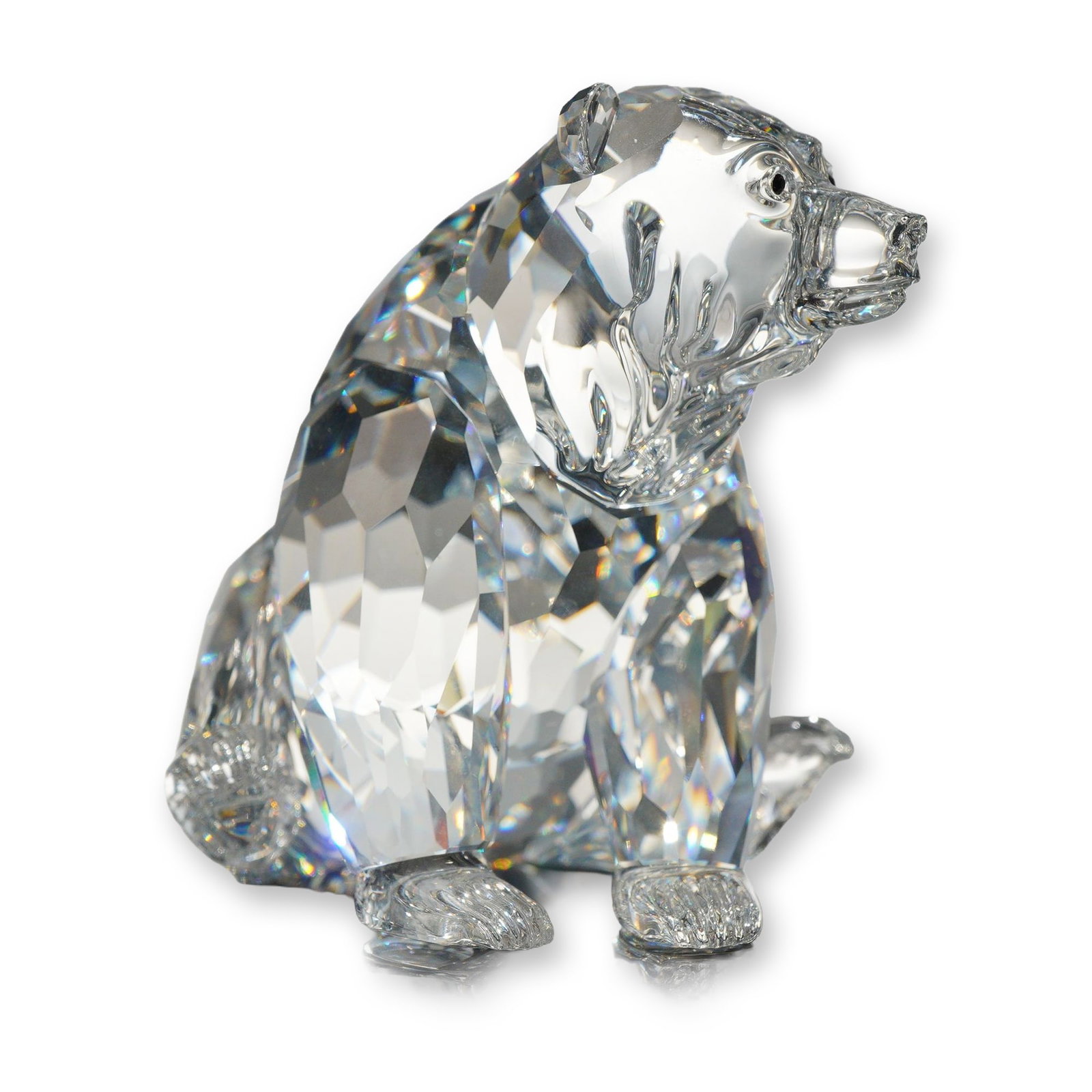 Swarovski Crystal Grizzly Bear Figurine: Swarovski Silver Crystal Grizzly Bear figurine, model 7637 000 006. Crafted in faceted clear lead crystal, the seated bear features molded ears and snout. Features the acid-etched Swarovski swan logo 