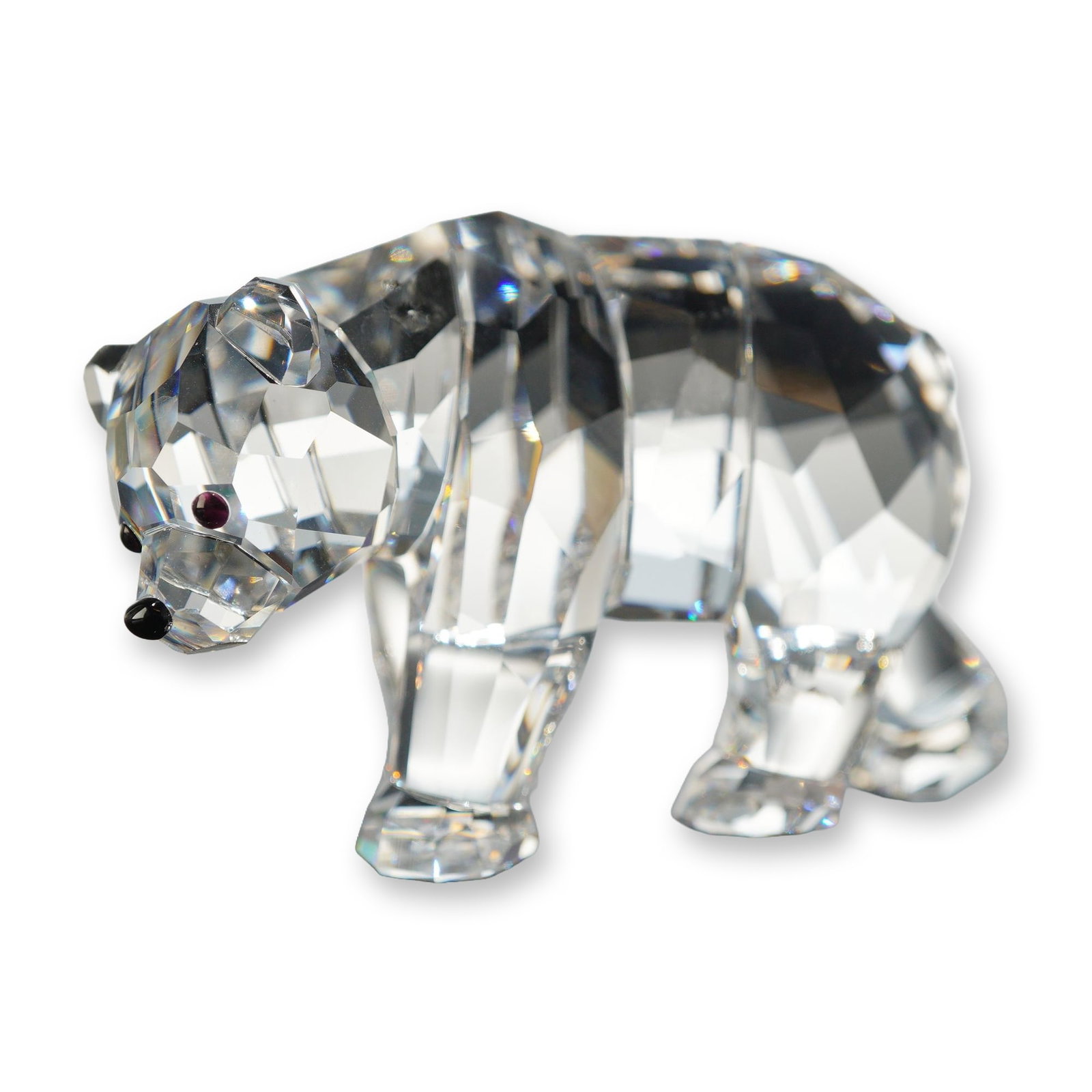 Swarovski Silver Crystal Sister Bear Figurine: Swarovski crystal Sister Bear figurine for SCS members, rendered in faceted clear lead crystal with crystal accents for the nose and eyes. The stylized bear is depicted in a walking stance with a lowe