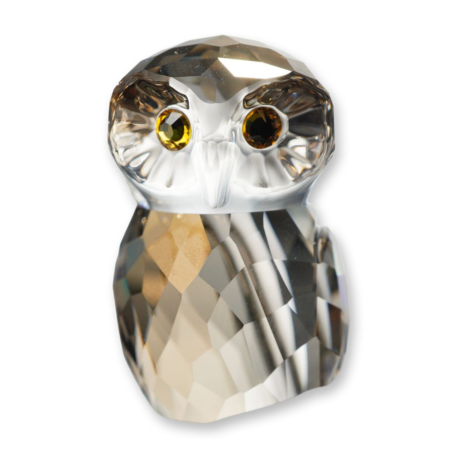 Swarovski Crystal Figurine, Brown Owl: Swarovski crystal medium owl figurine, Austrian, featuring a faceted smoky golden-brown tinted body, a clear faceted head with yellow and black crystal eyes, perched on a frosted crystal branch base. 