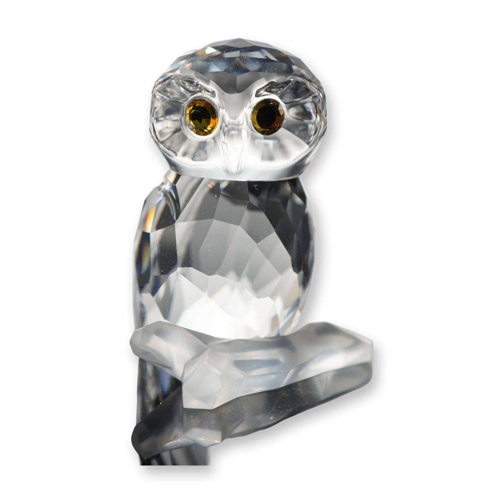 Swarovski Crystal Mini Owl Figurine: Swarovski faceted lead crystal figurine depicting a mini owl perched upon a frosted crystal branch. The owl is detailed with amber-colored eyes and a faceted body. The underside of the tail features a