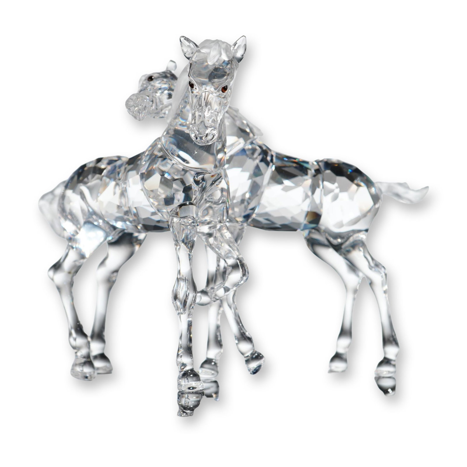 Swarovski Crystal Figurine, Foals: Foals figurine from the Peaceful Countryside collection, composed of faceted clear lead crystal depicting two young horses in an affectionate pose. The manes and tails feature a frosted or satin-finis