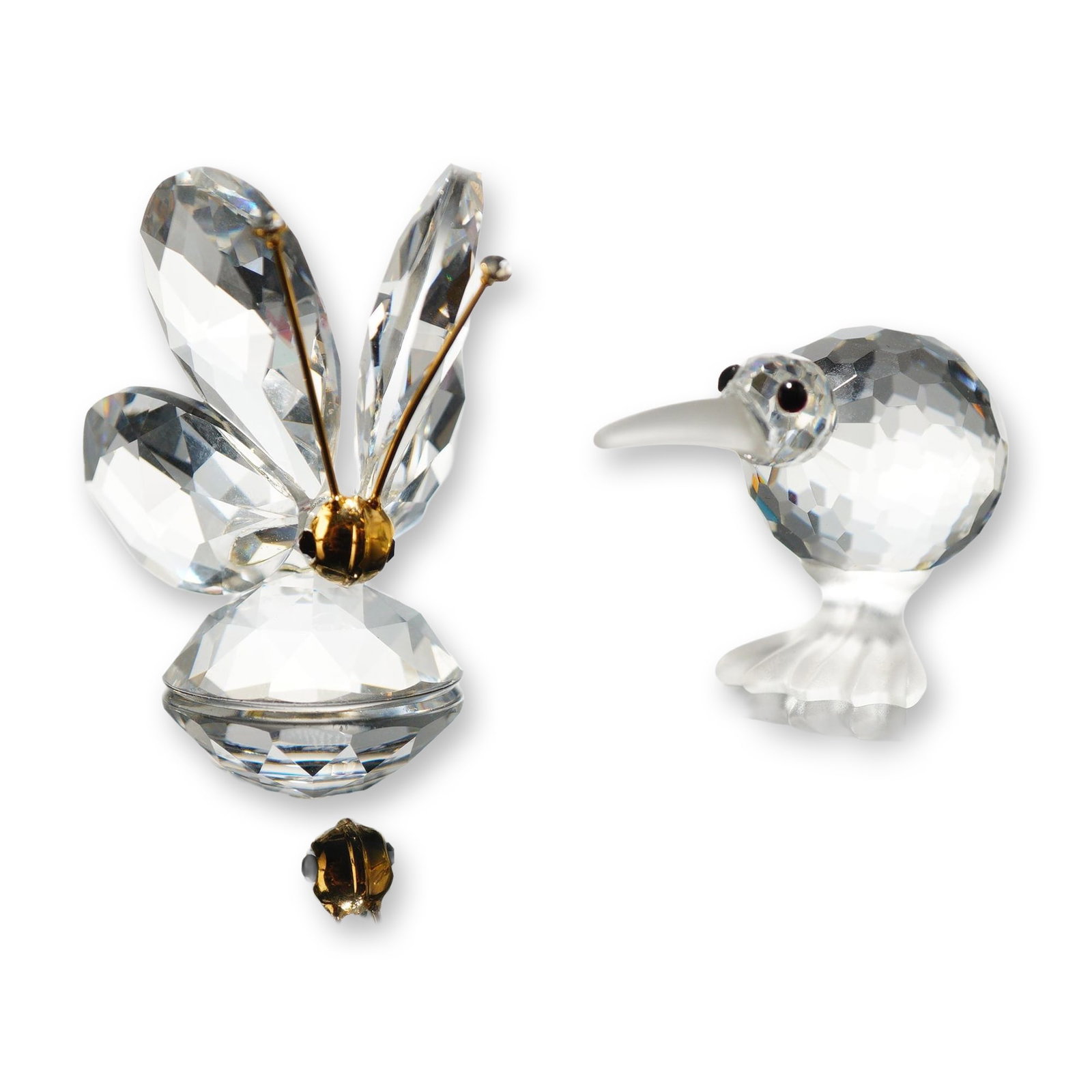 2pc Swarovski Silver Crystal Kiwi Bird and Butterfly Figurines: Swarovski Silver Crystal animal figurines, comprising a kiwi bird and a butterfly. The kiwi bird features a faceted crystal body and head with a frosted crystal beak and feet, and small black bead eye