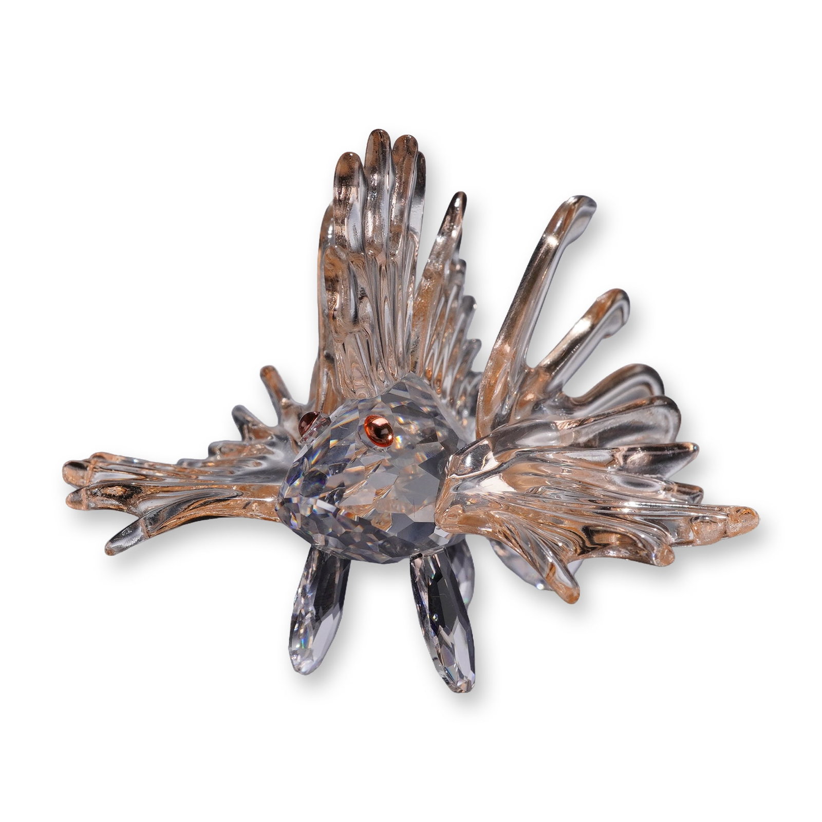 Swarovski Crystal South Sea Figurine, Lion Fish: South Sea Lionfish figurine in faceted lead crystal, featuring a clear faceted body with flowing fins accented by light, amber-toned tips and inset reddish-brown crystal eyes. Marked with the acid-etc