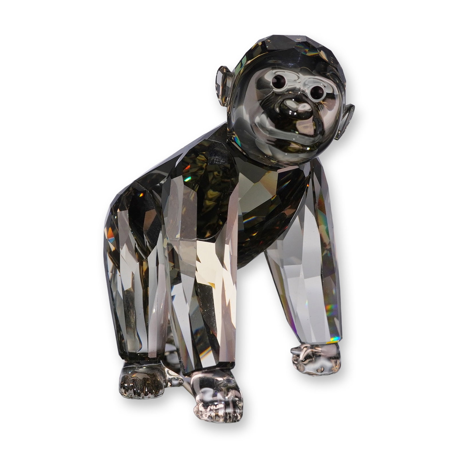 Swarovski 2009 SCS Annual Edition Crystal Figurine, Gorilla Cub: Swarovski Crystal Society (SCS) 2009 companion Gorilla Cub figurine in faceted Moroda shadow crystal. The figure features a clear crystal face, hands, and feet with dark eyes, depicted in a naturalist